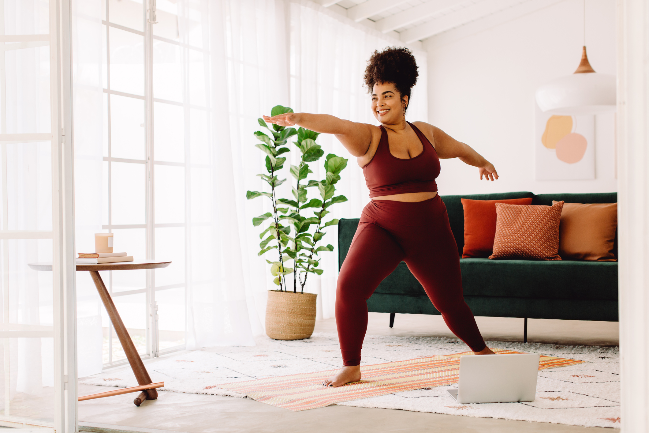 Healthy woman doing yoga at home