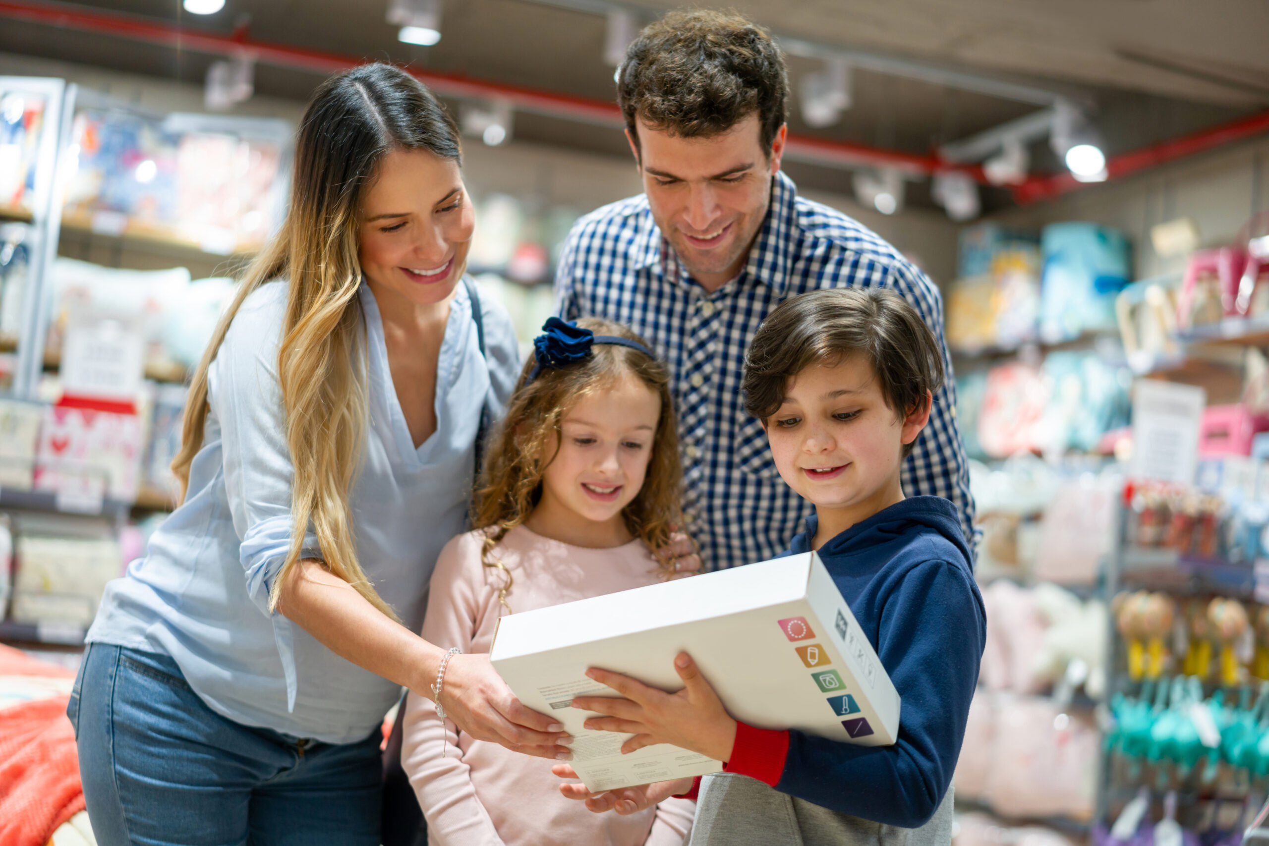 Happy family shopping and buying toys for the kids at a department store