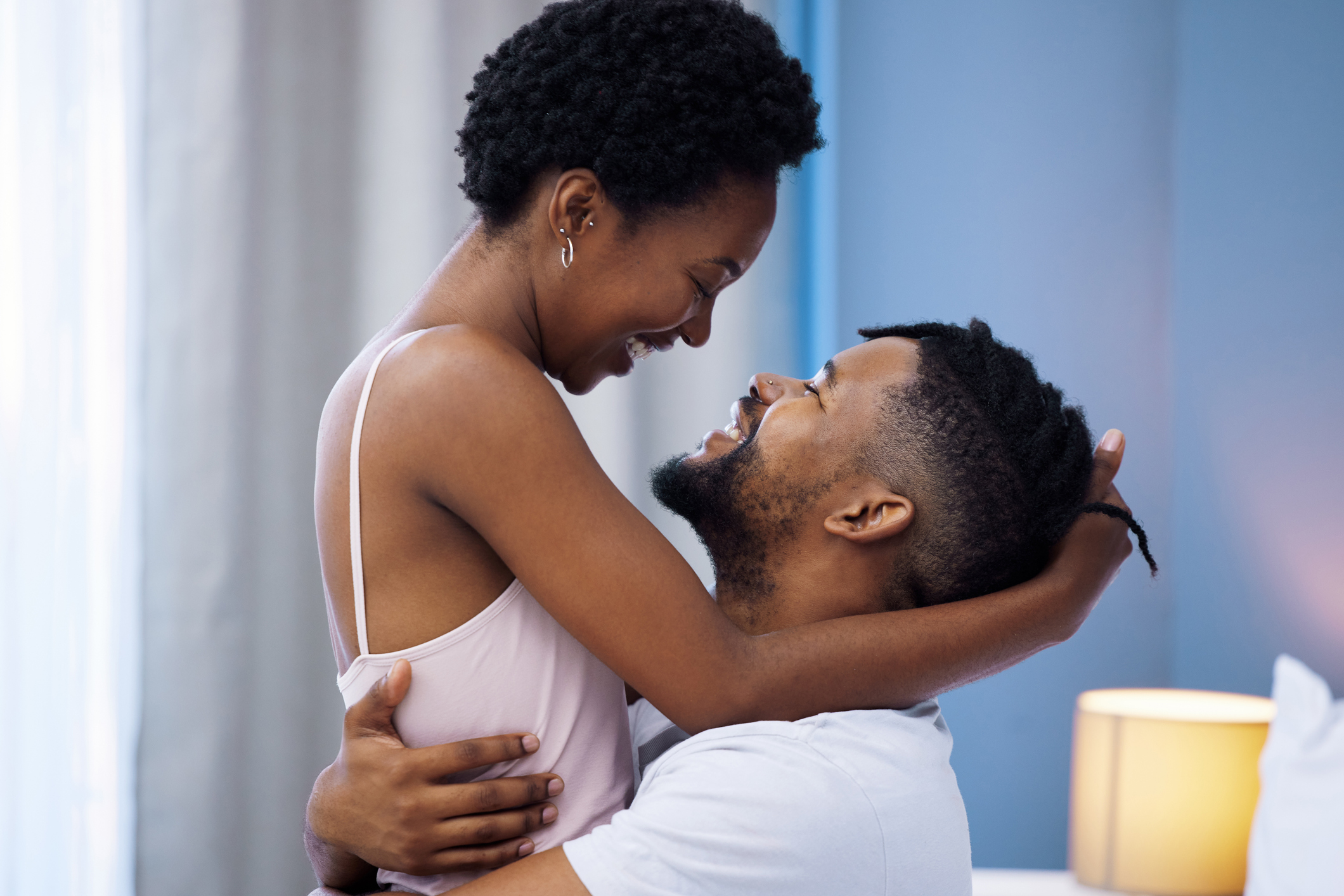 Shot of a young couple being intimate in bed at home