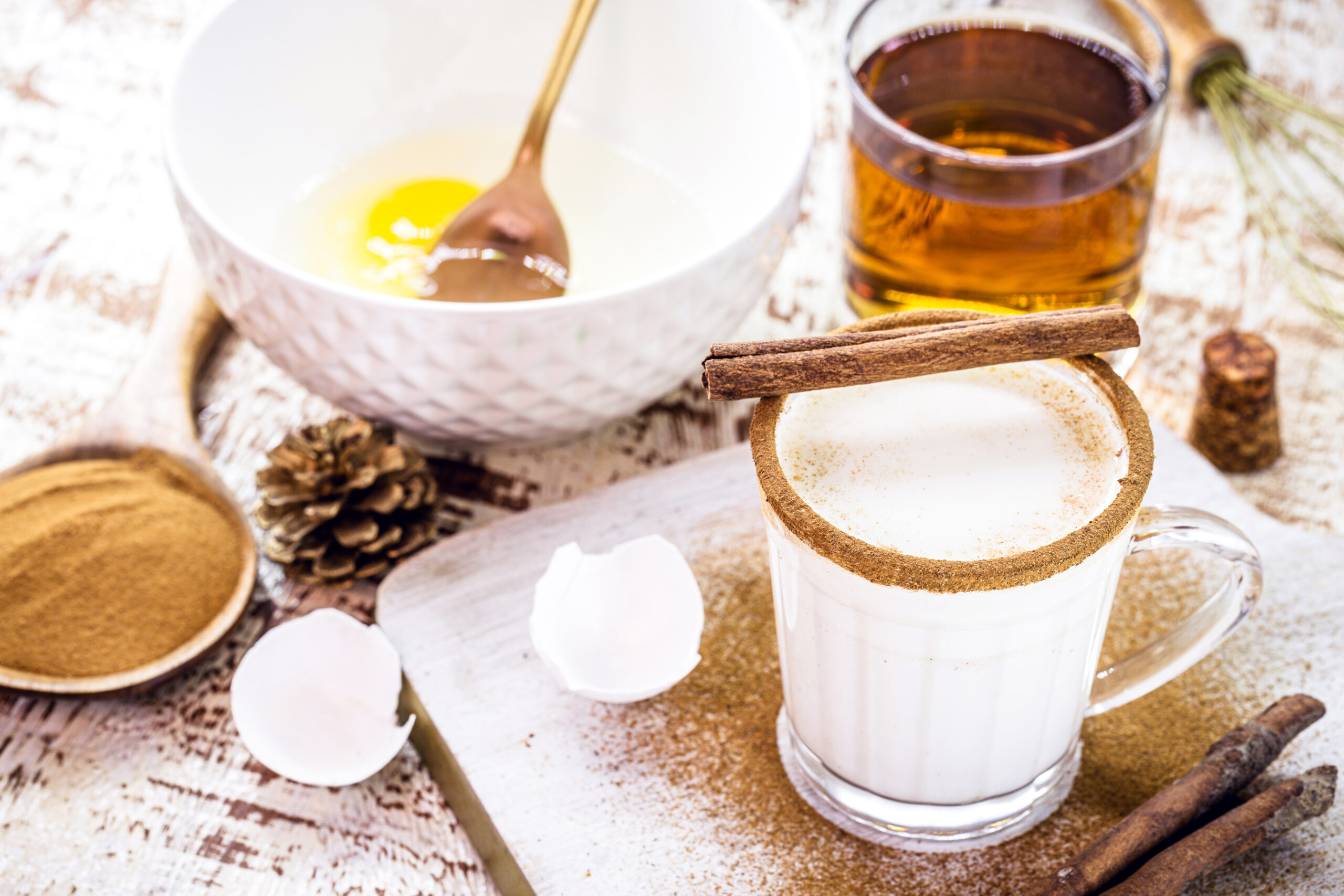 preparation of Christmas eggnog, Christmas drink recipe, with eggs, sugar, cinnamon, rum and cream