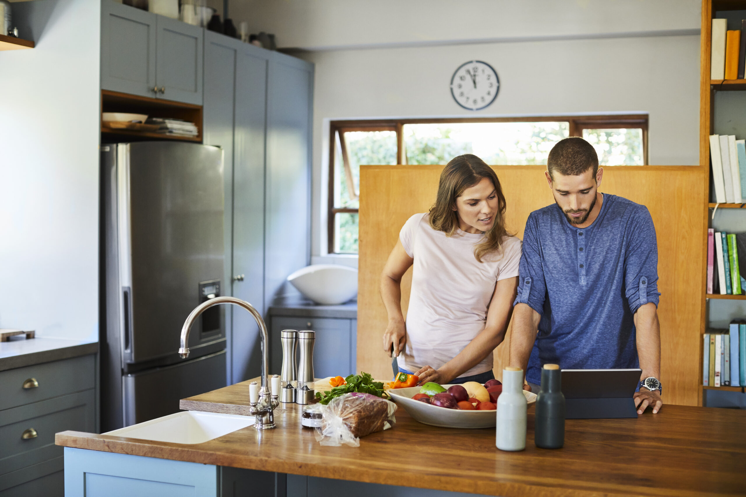 Couple preparing food together in kitchen at home