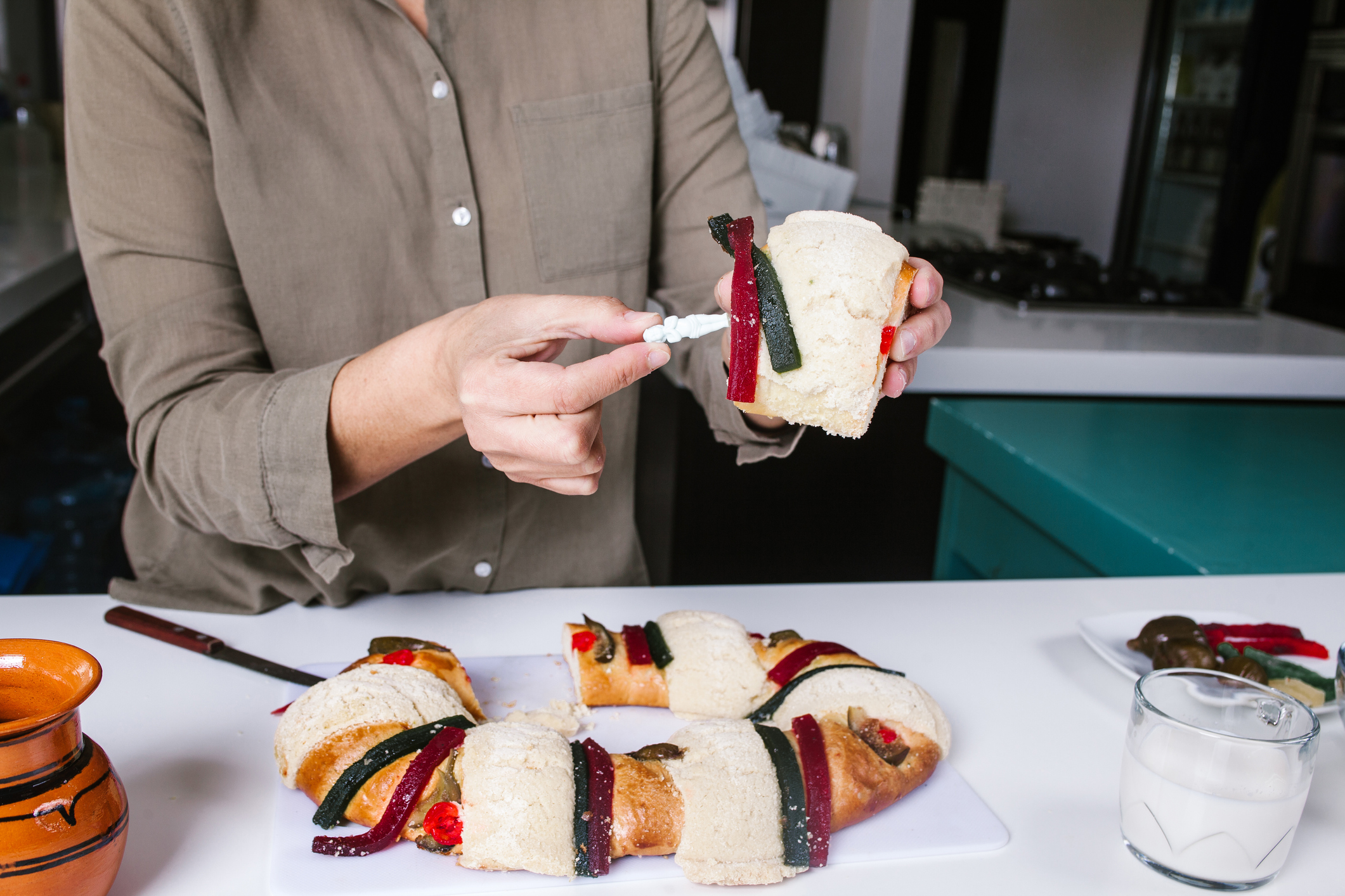 Mexican woman eating rosca de reyes or Epiphany cake, Roscon de reyes with traditional mexican chocolate cup