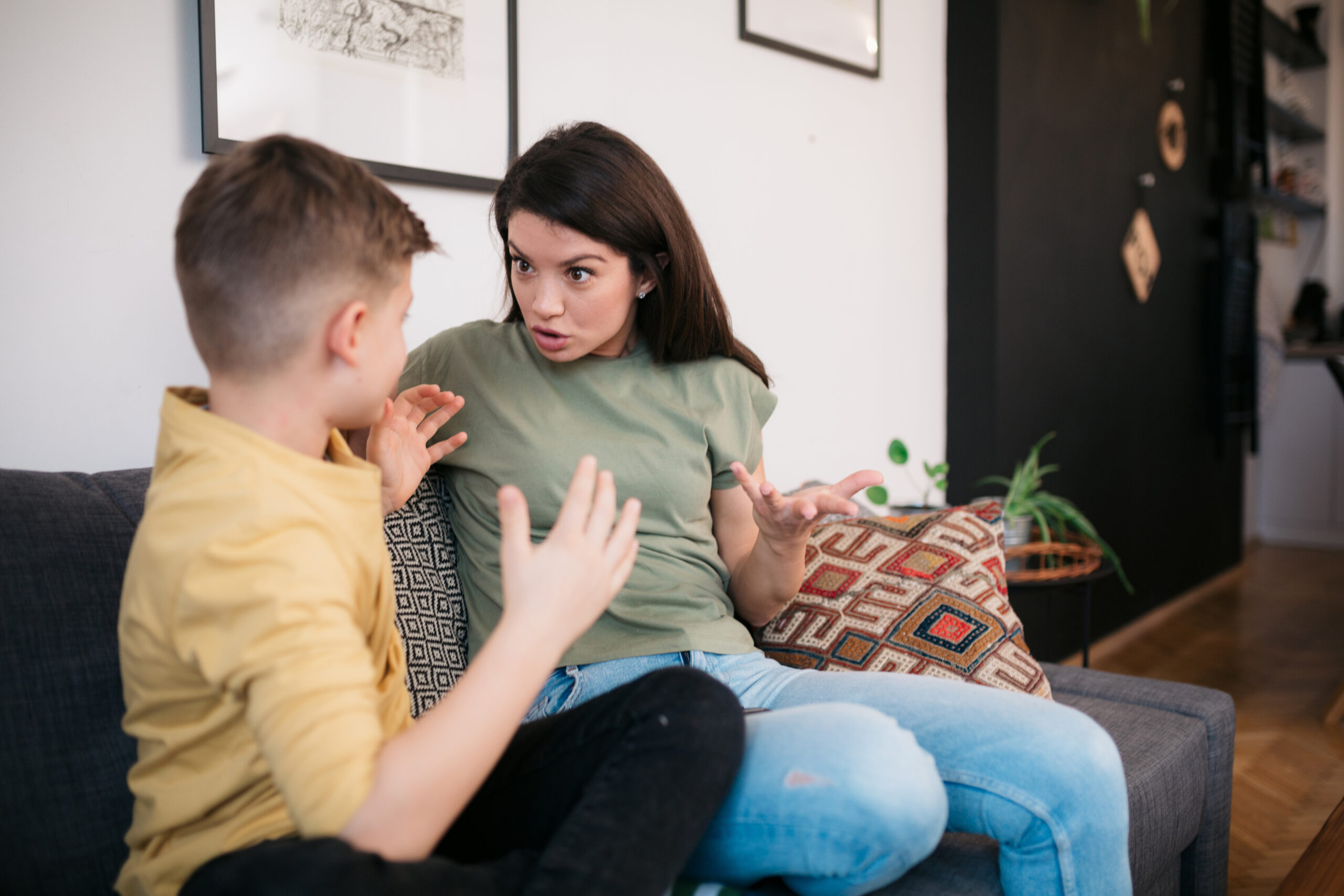 Young Caucasian mother at home with her teenage son