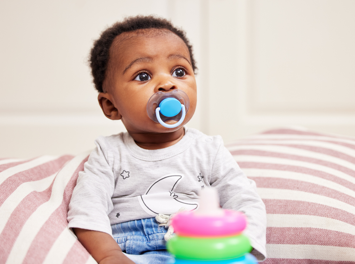 Shot of a little baby sitting on a bed