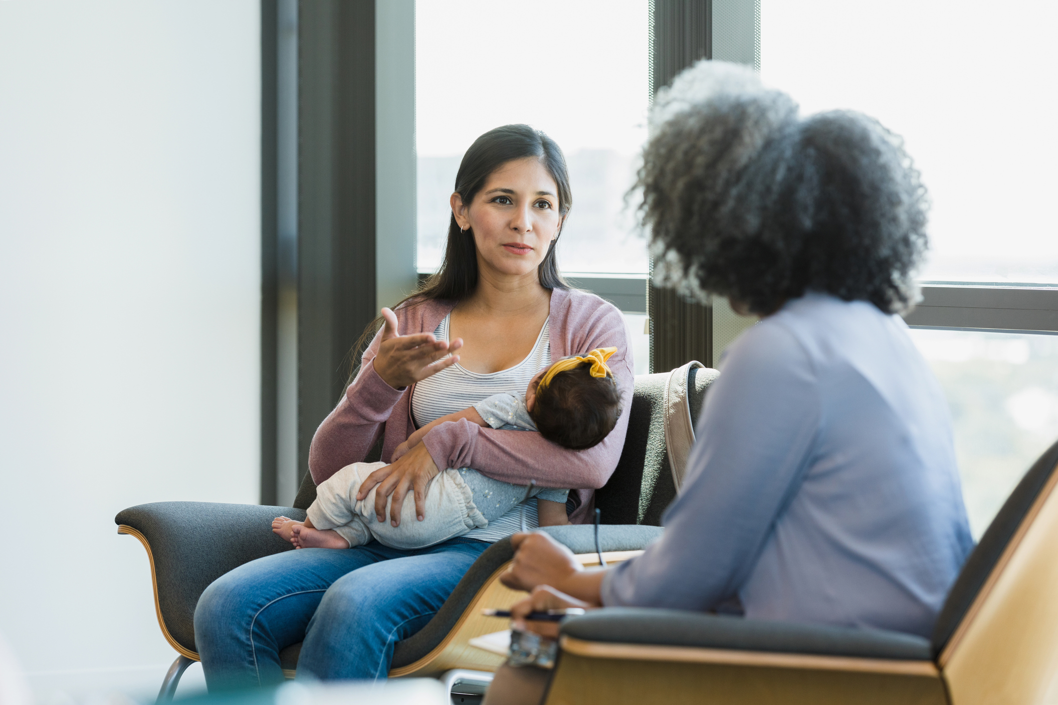 Woman gestures while sharing struggles with therapist