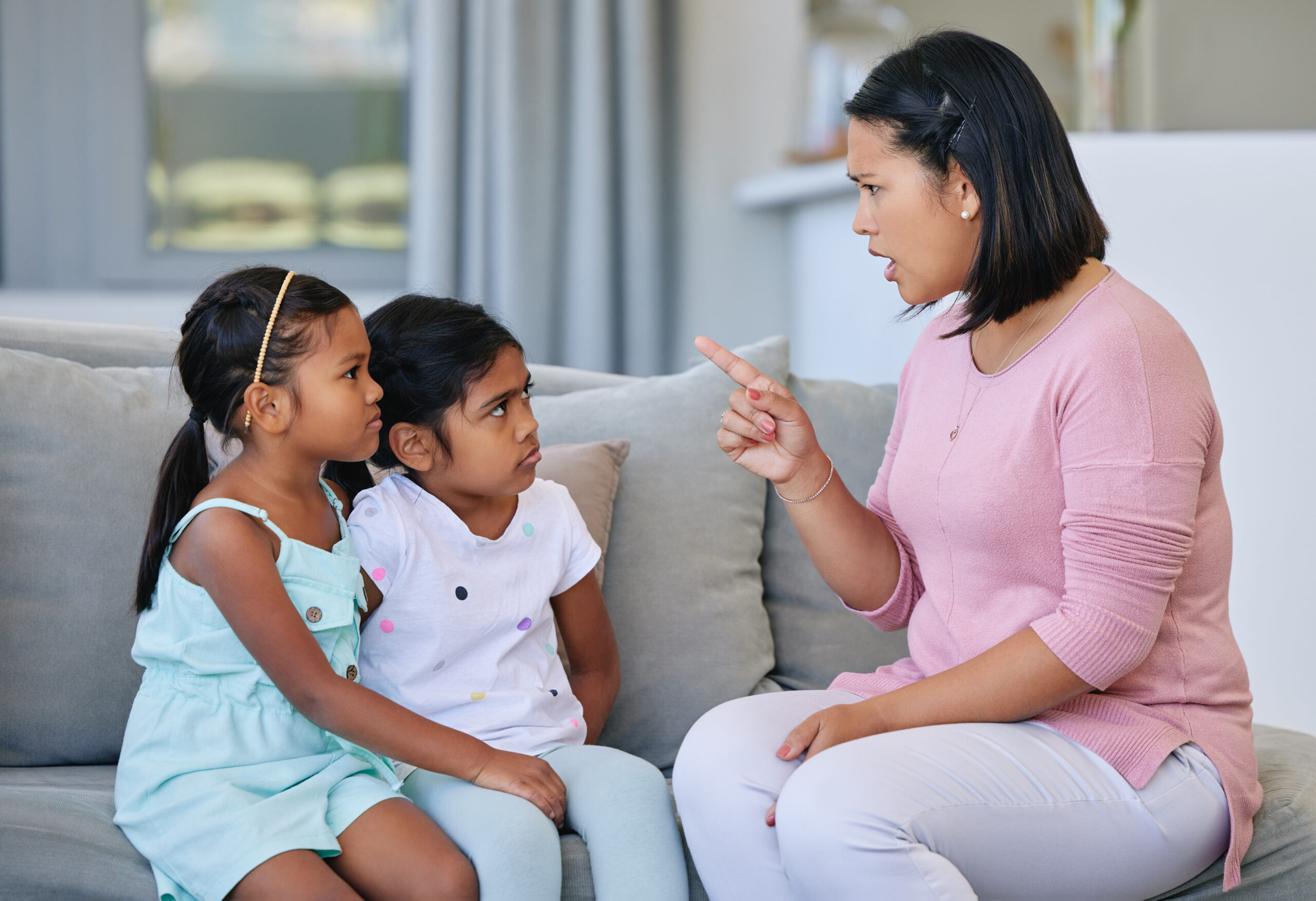 Shot of a woman scolding her two daughters