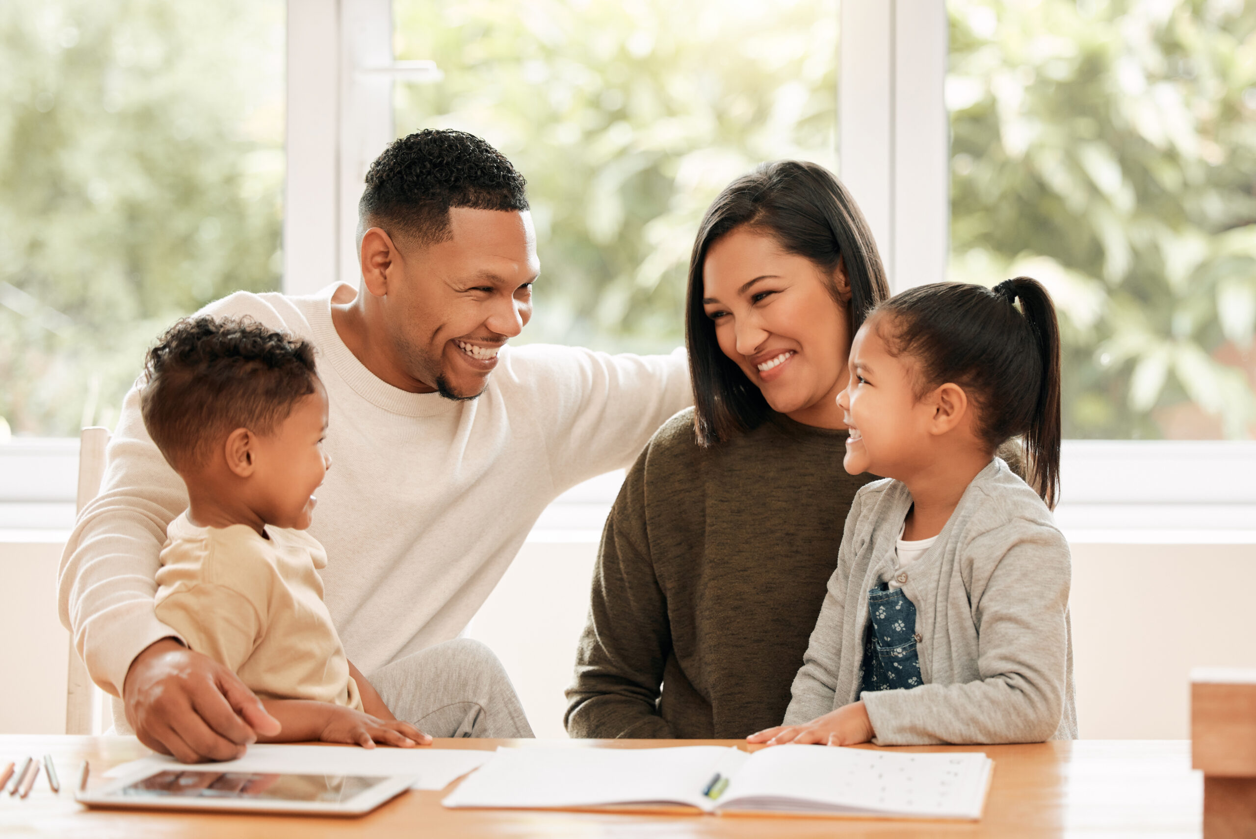 Shot of a young family doing homework together at home