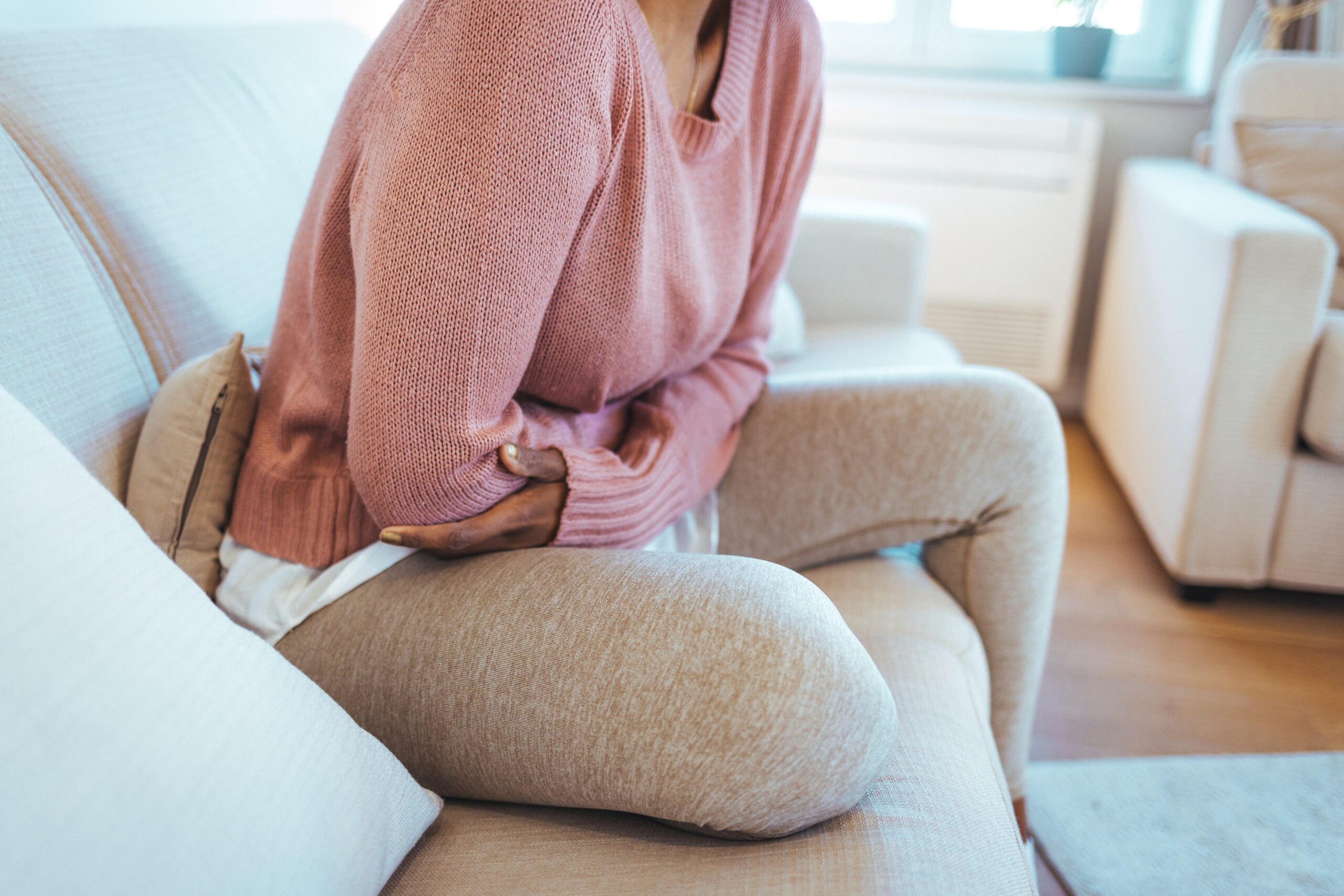 Cropped shot of an attractive young woman lying down on her bed and suffering from period pains at home.