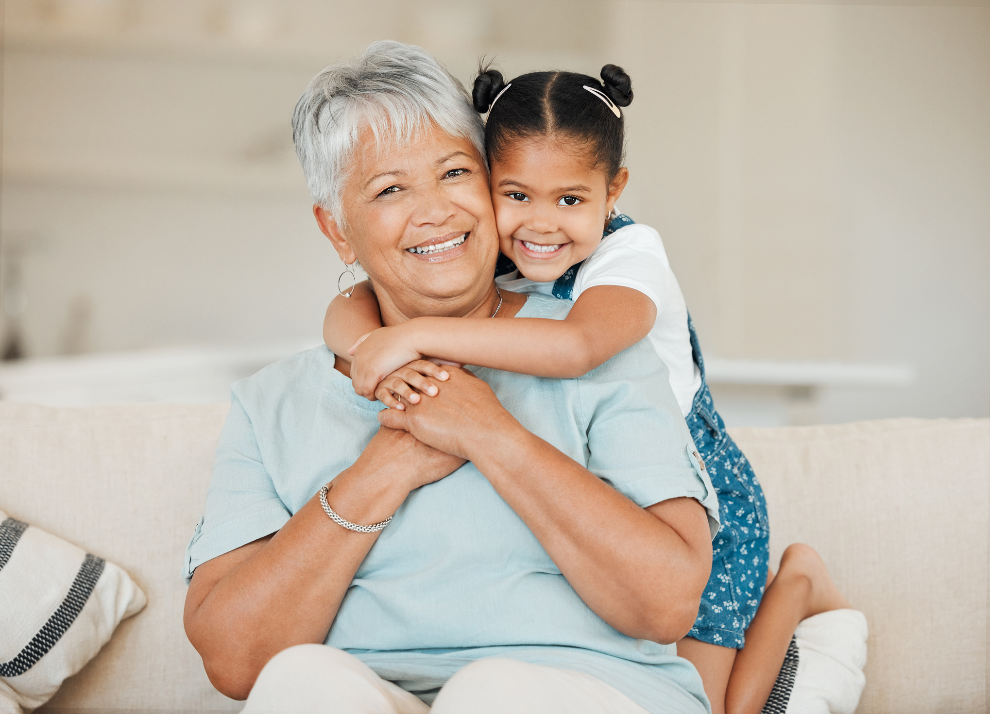 Shot of a grandmother and granddaughter bonding on the sofa at home