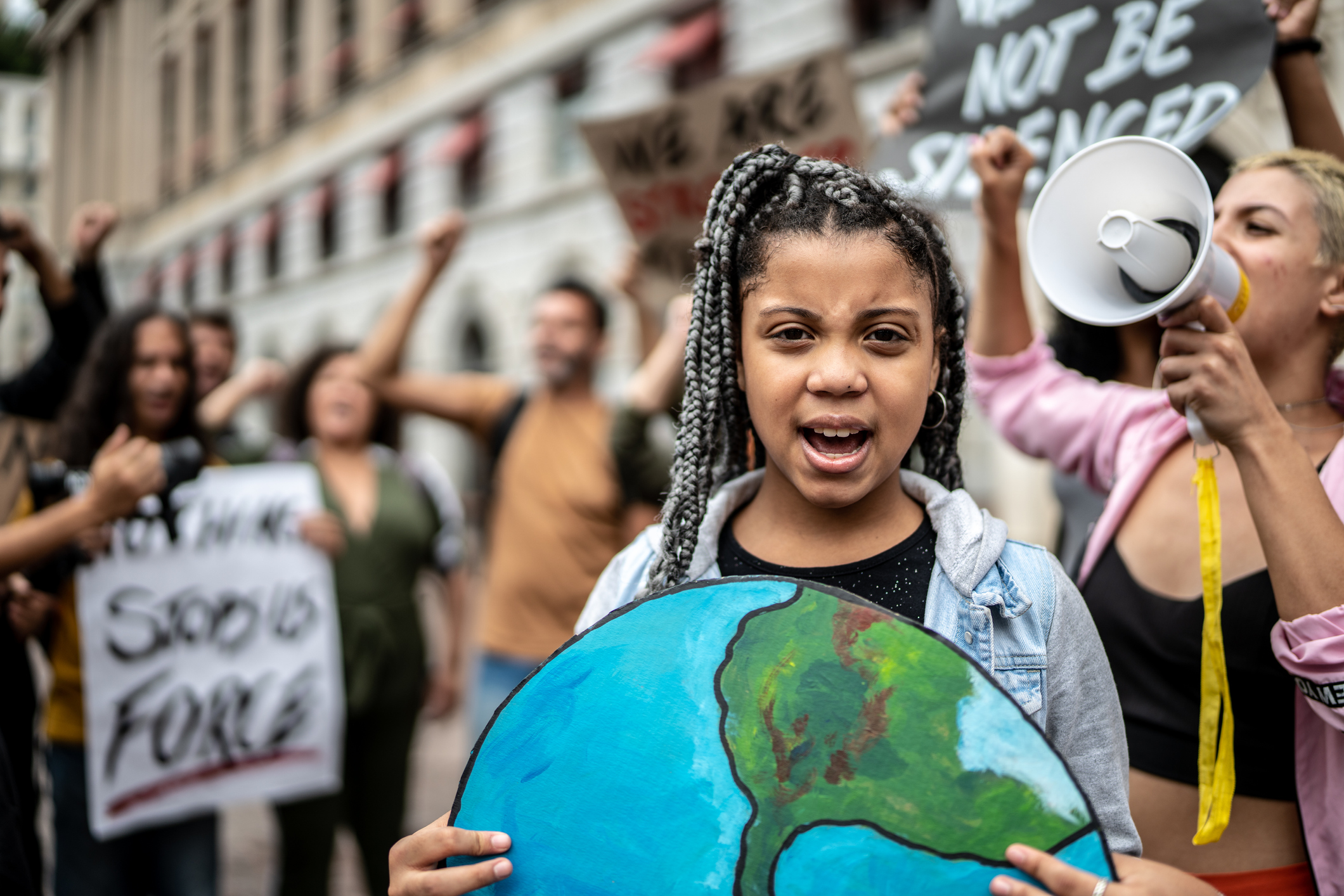 Portrait of teenage girl holding signs during on a demonstration for environmentalism