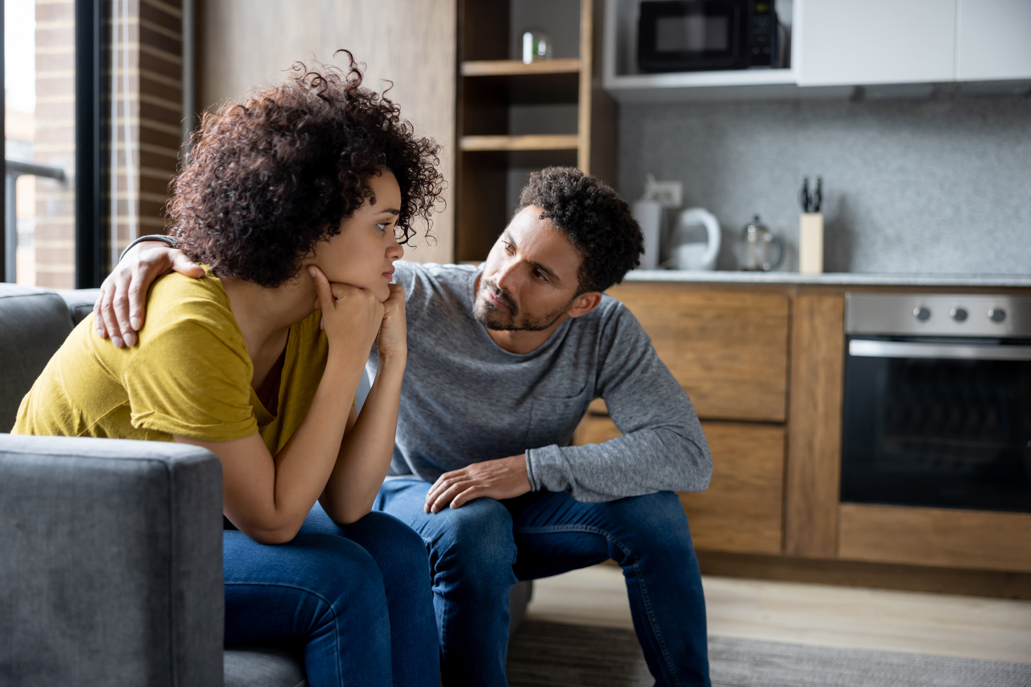 Man comforting his girlfriend at home