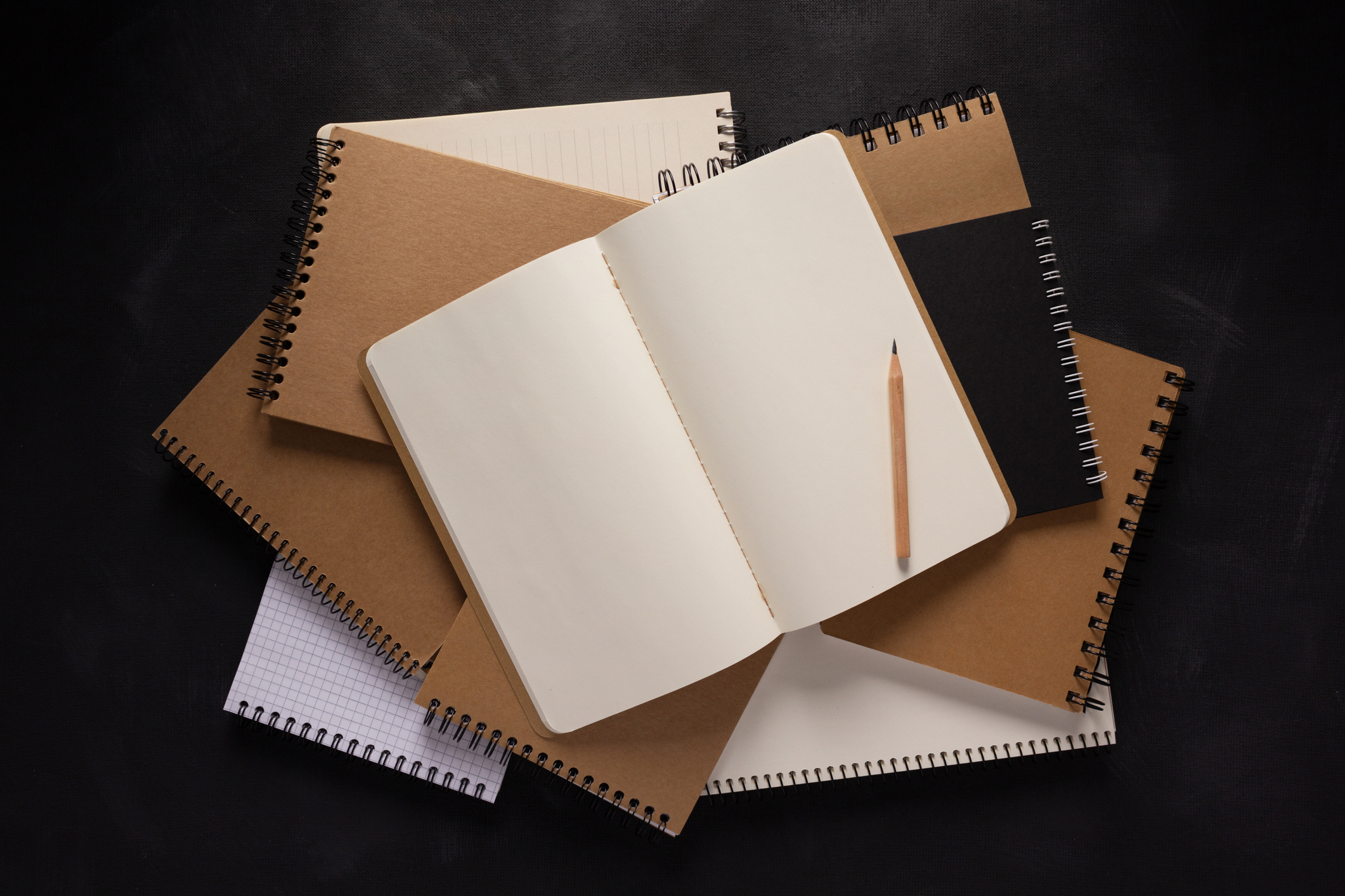 Paper notebook on black background texture. Creative idea concept