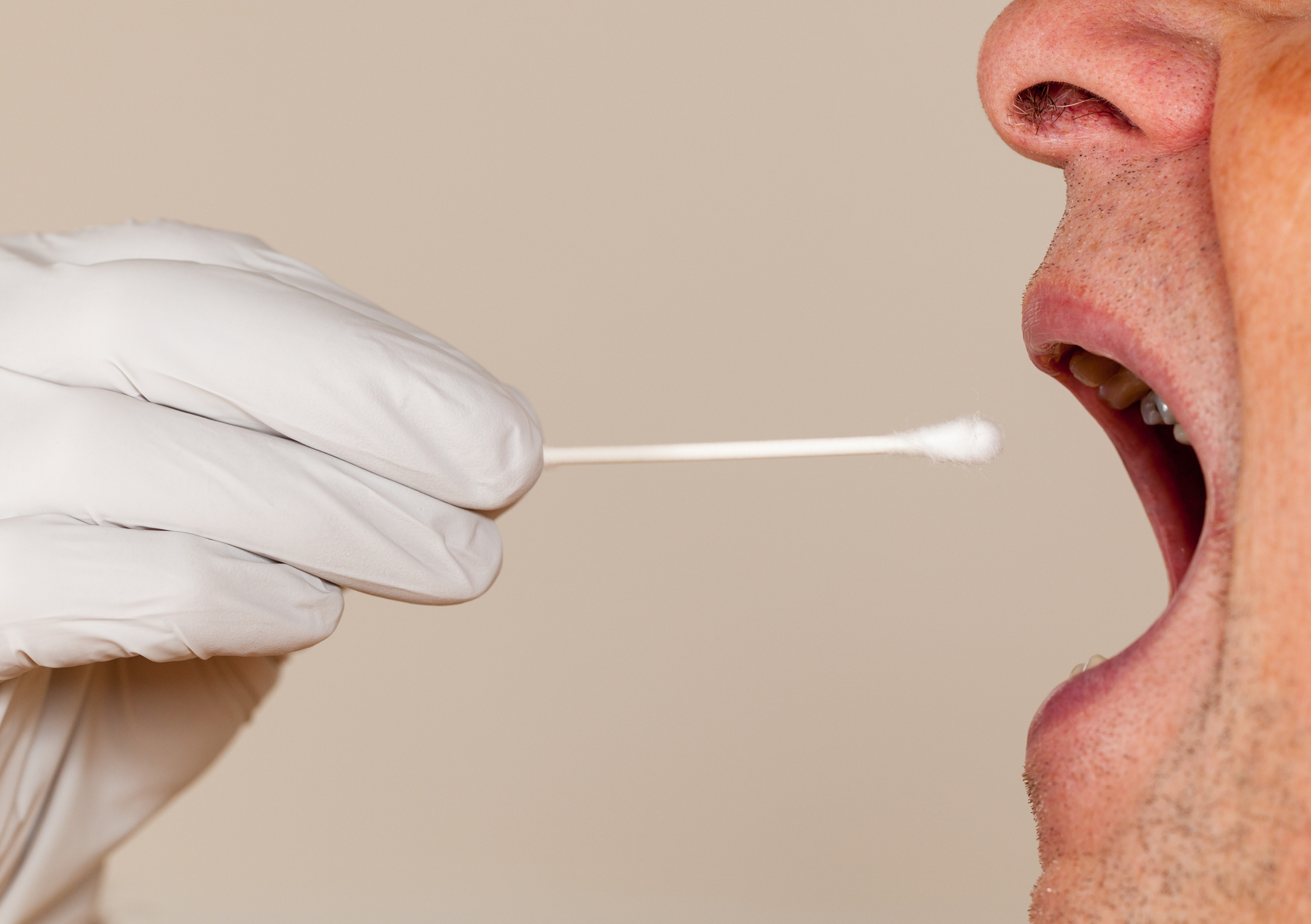 Side view of a mouth open for a DNA swab