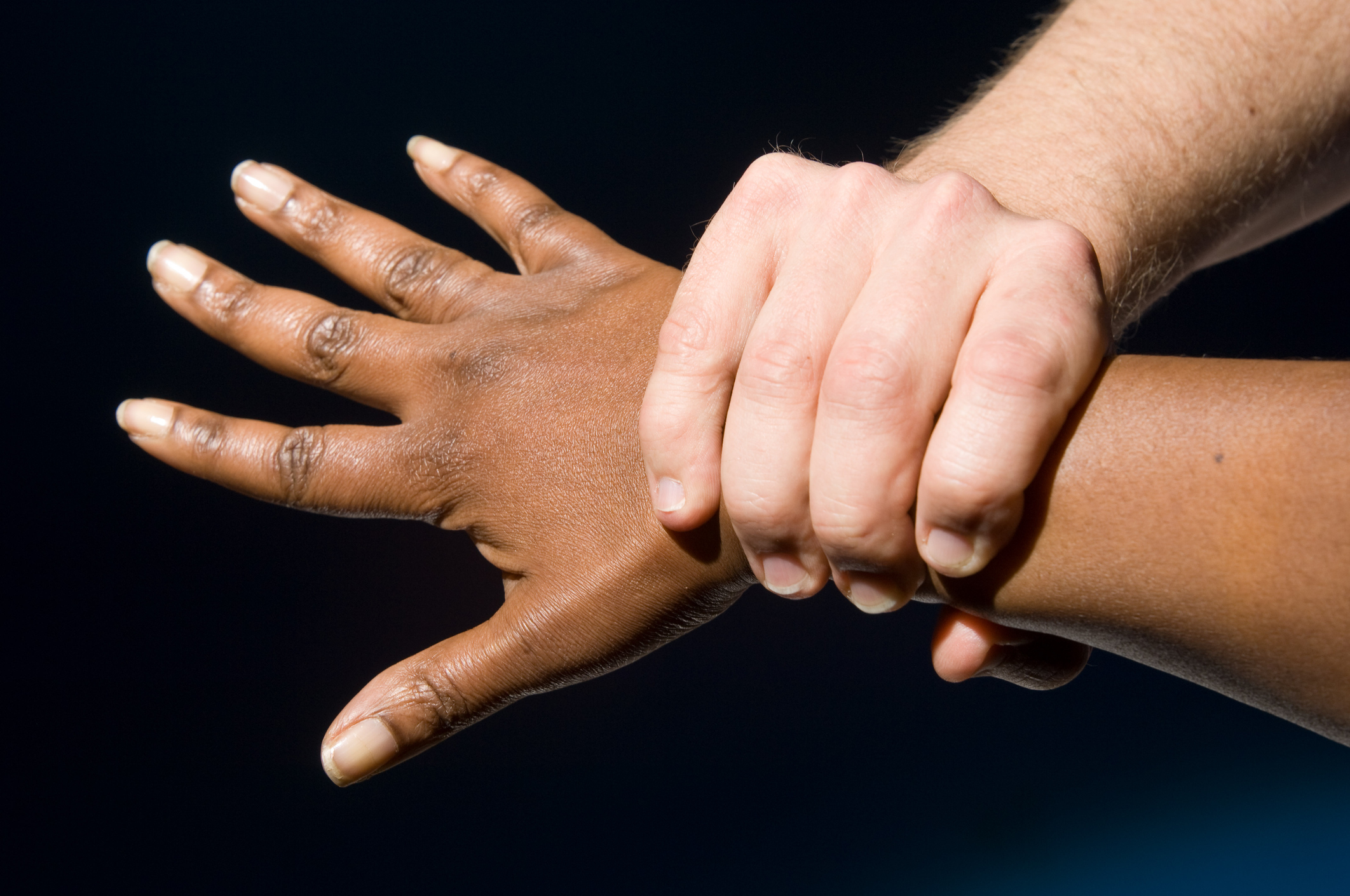 A hand grasping another persons wrist