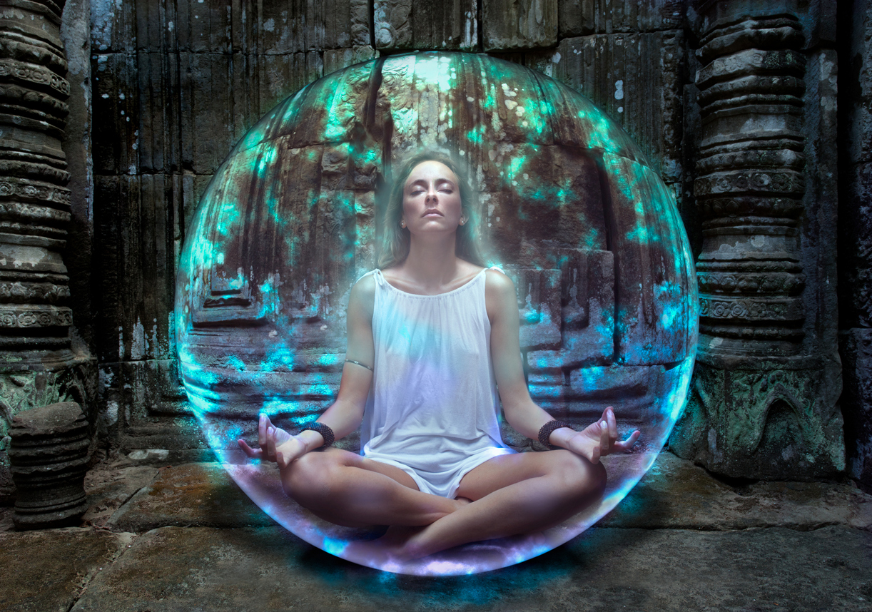 Young woman meditates inside protective bubble