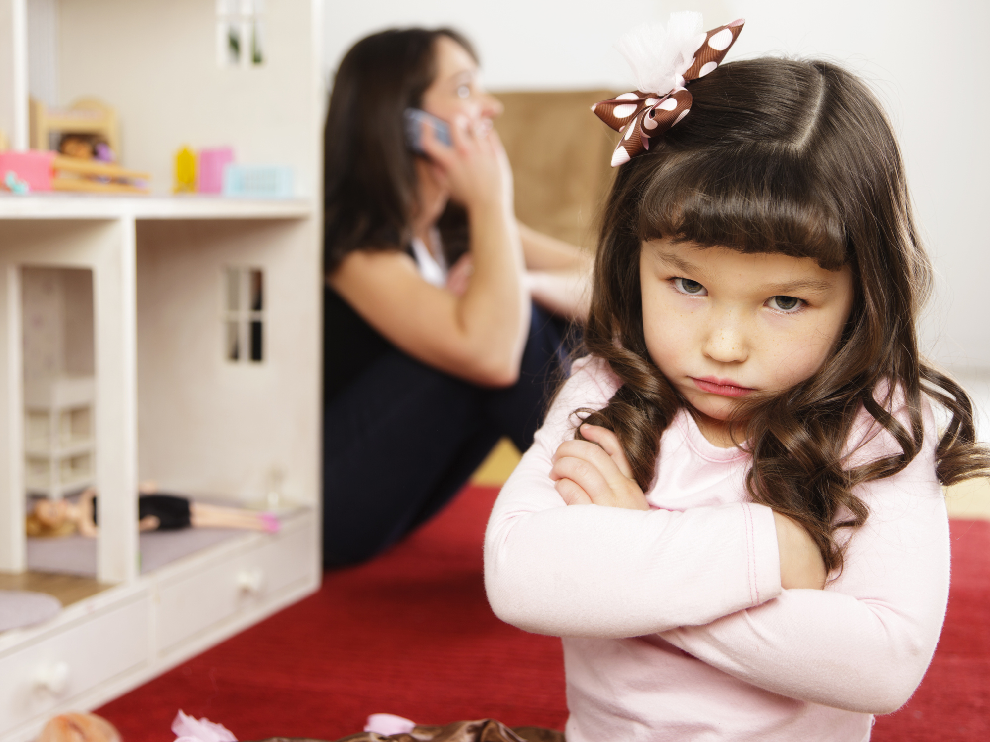 Unhappy little Girl with Dollhouse