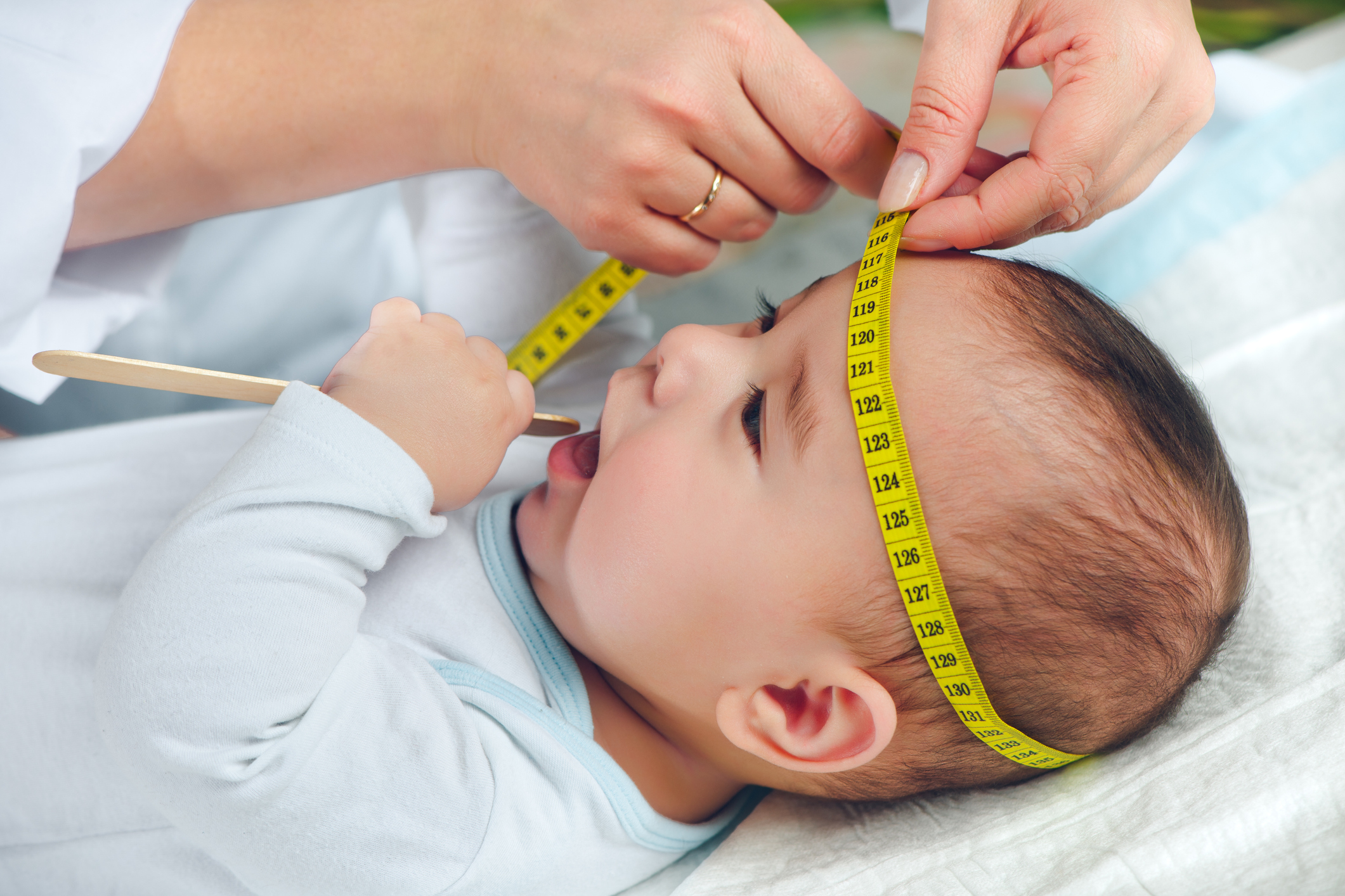 Pediatrician measuring baby's head