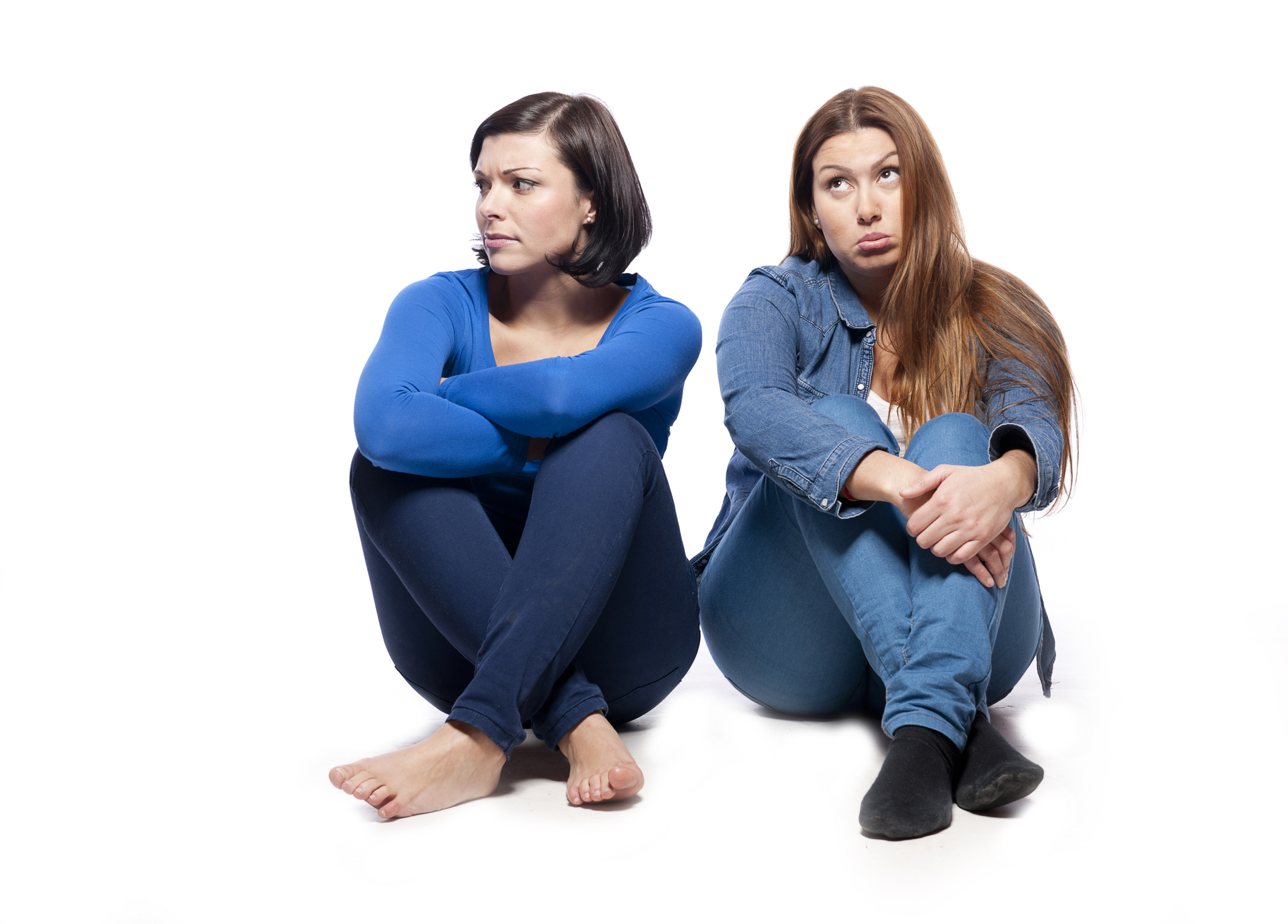 Two women sitting on ground