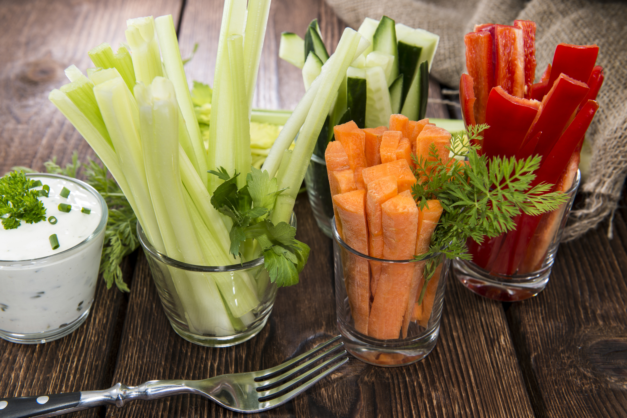 Fresh vegetables in clear glasses and white dip