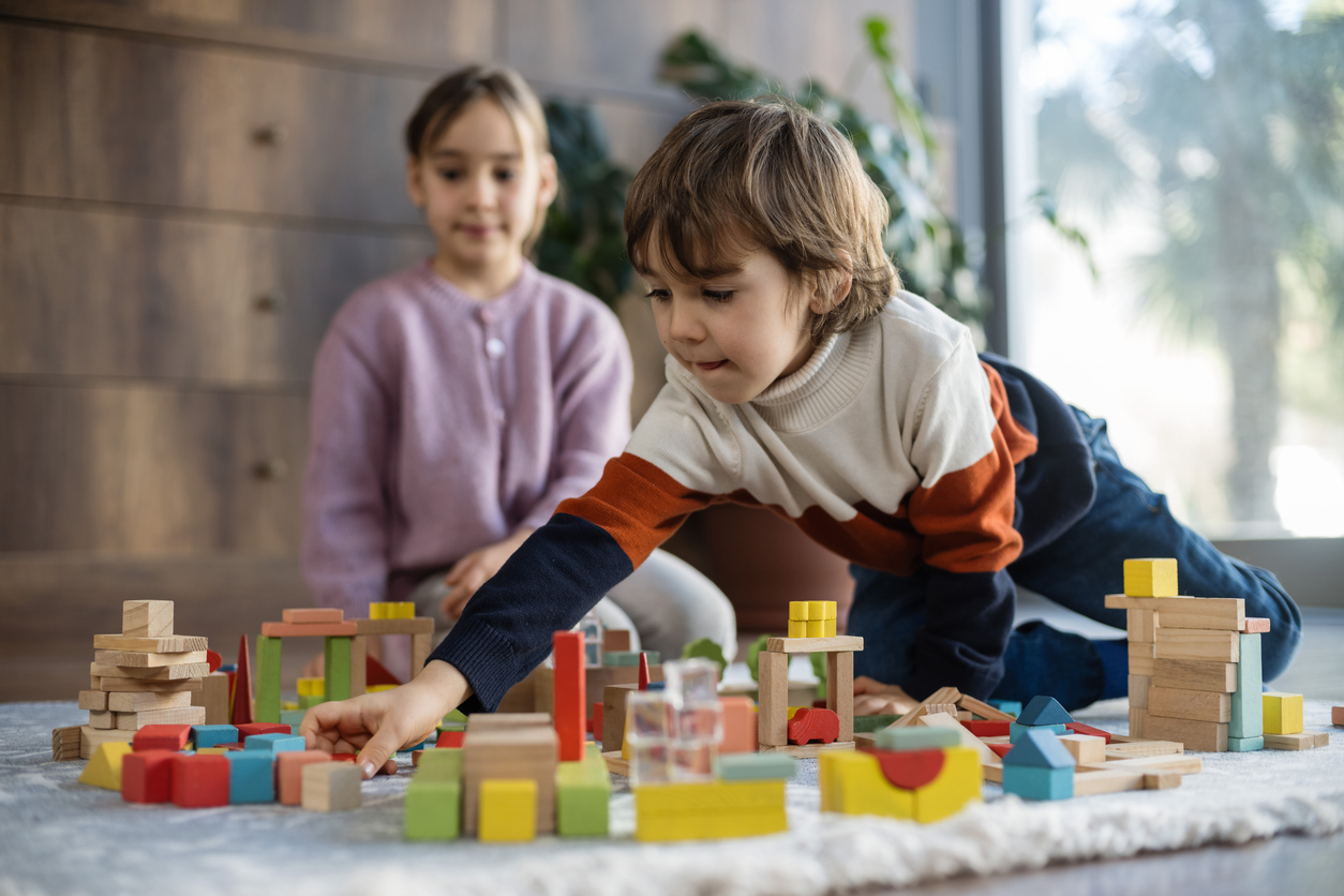 children playing with toy blocks at home together