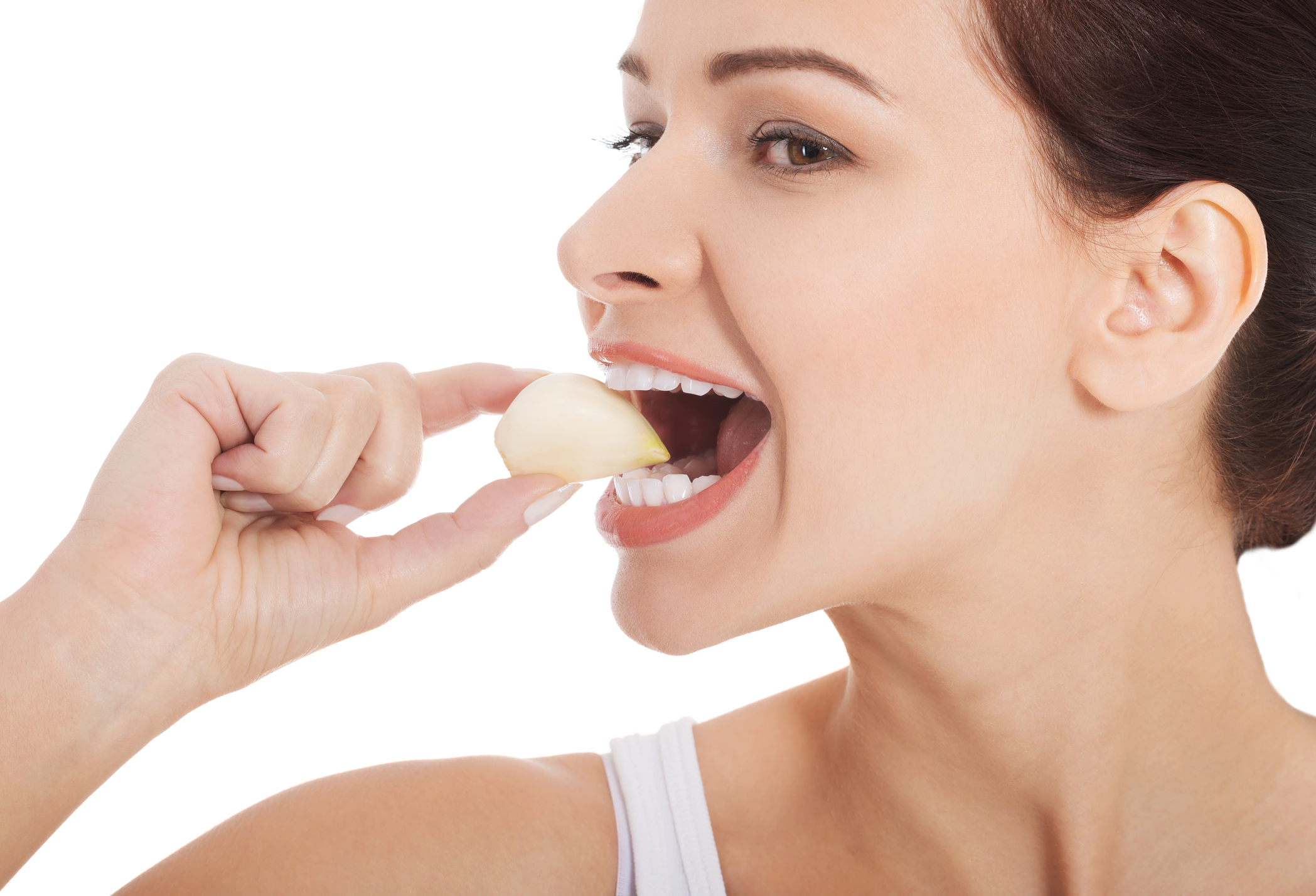 Beautiful woman eating garlic.