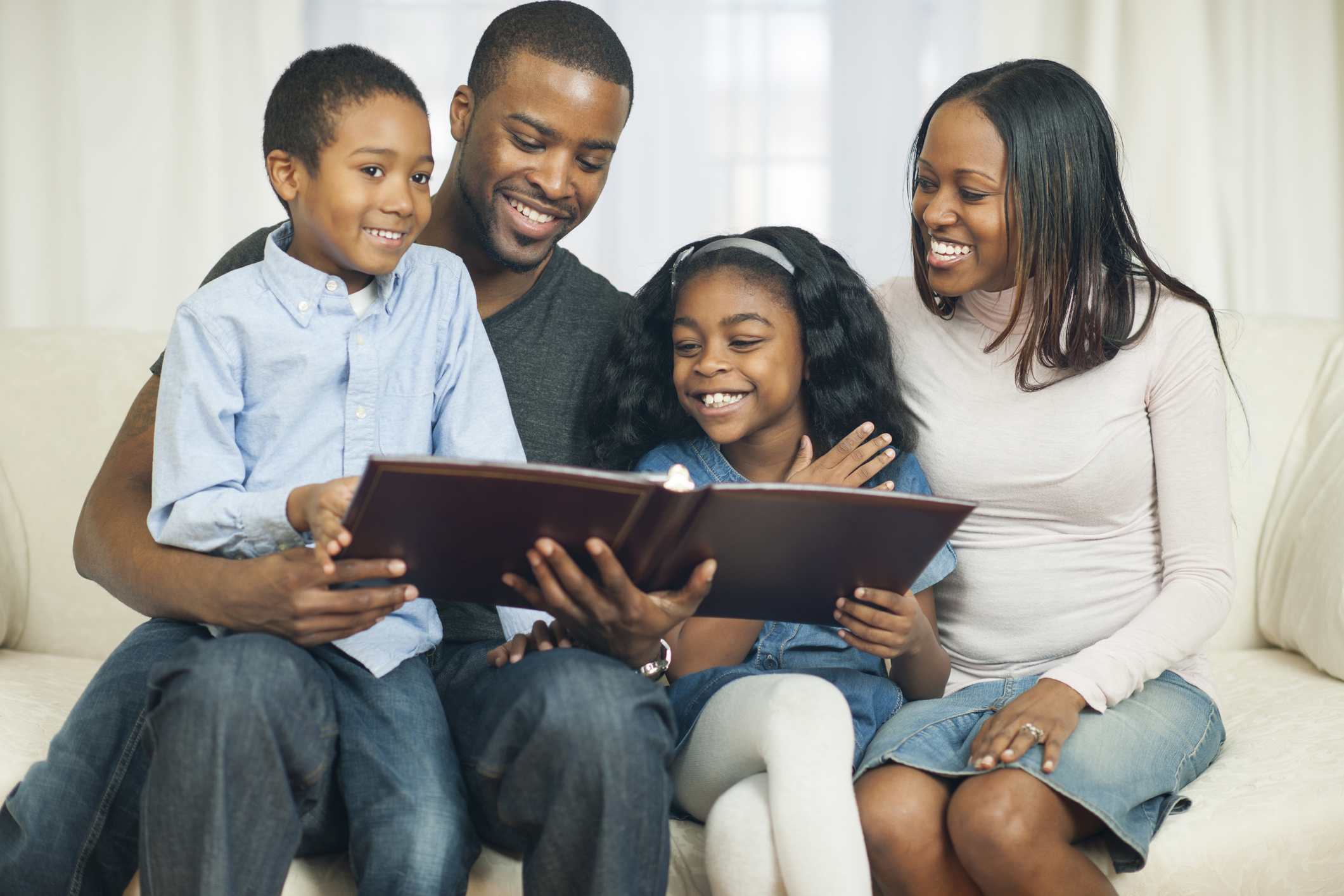 Family together reading photo album