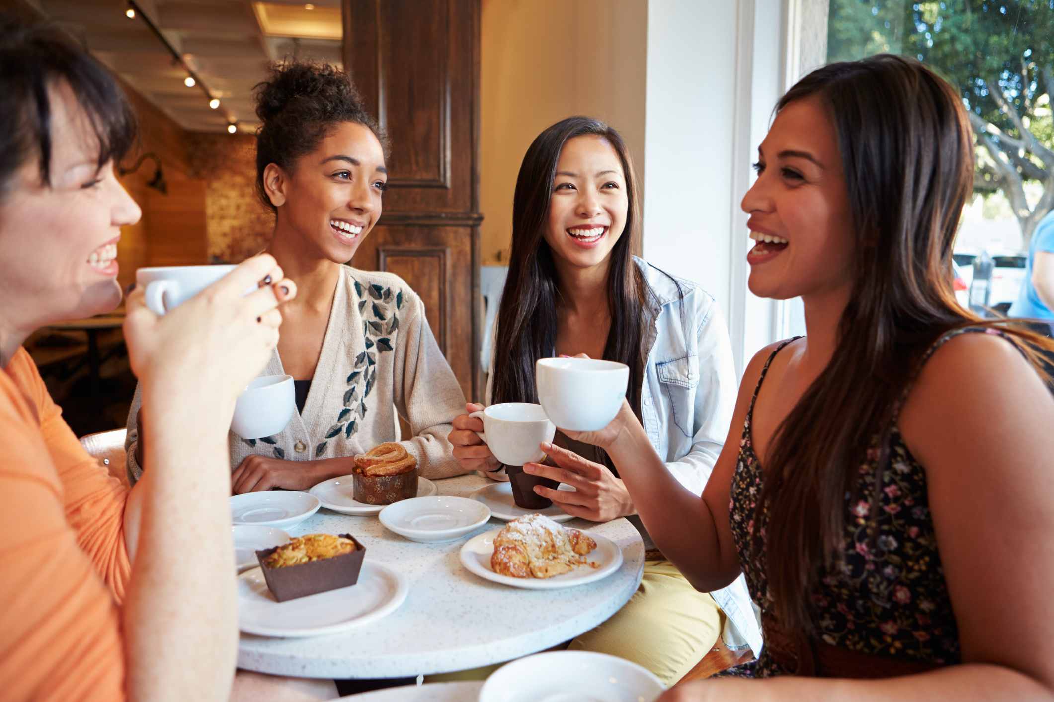 Group Of Female Friends Meeting In Café Restaurant