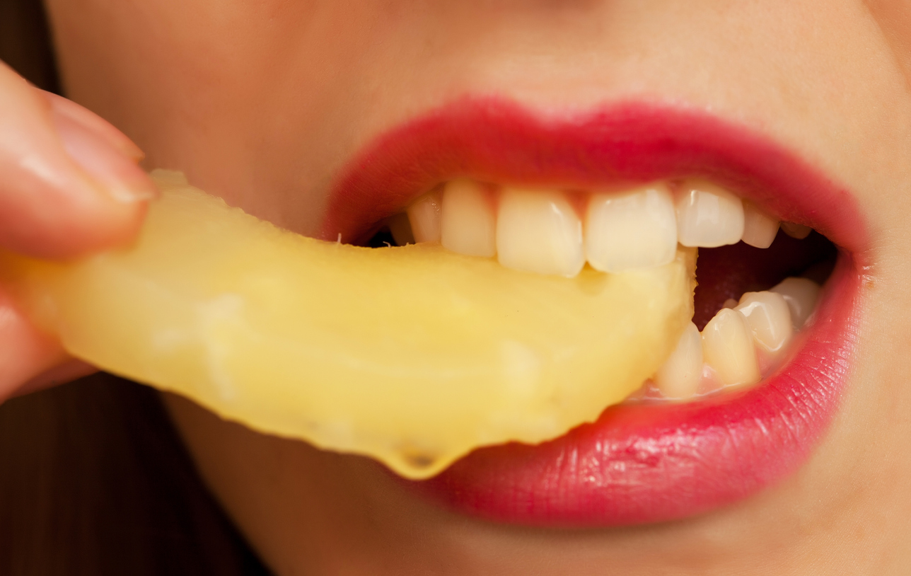 girl eating pineapple