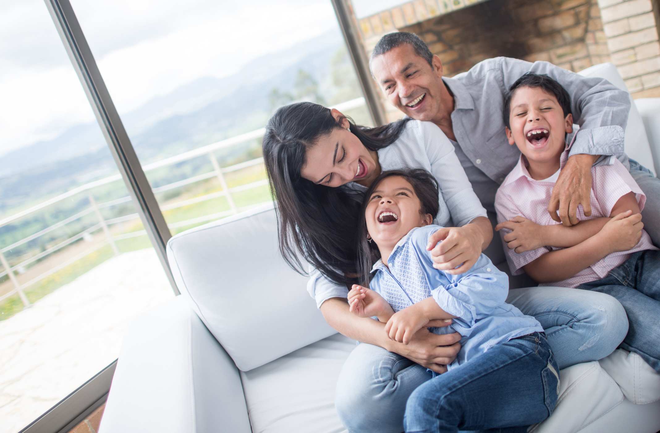 Family having fun tickling each other