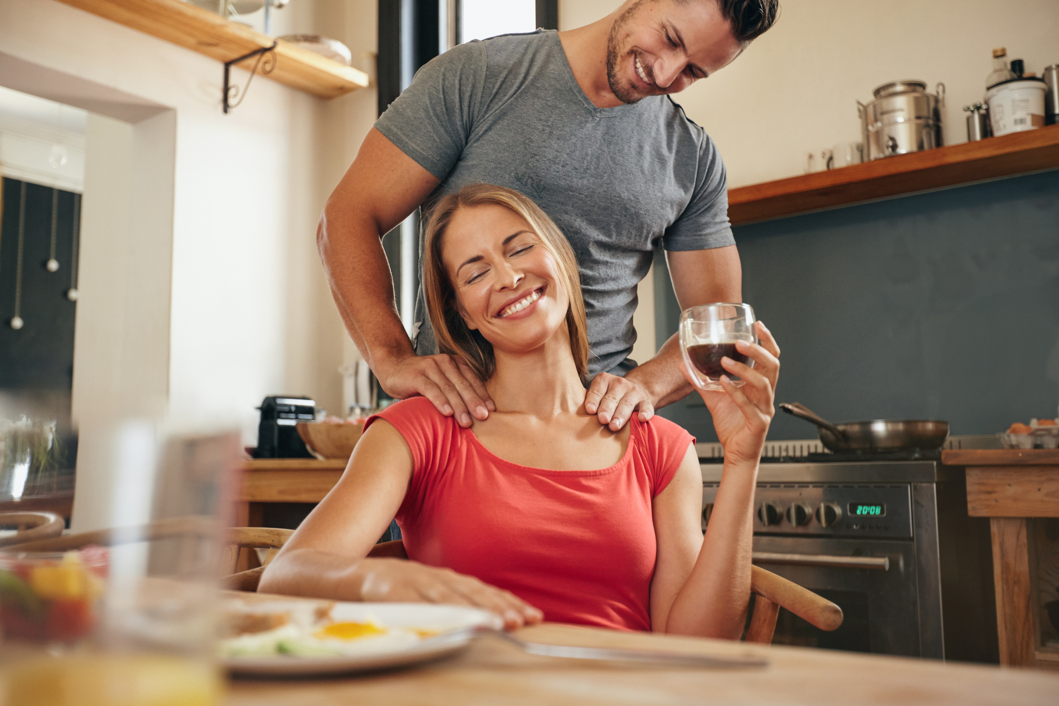 Woman relaxing while man massaging her shoulders