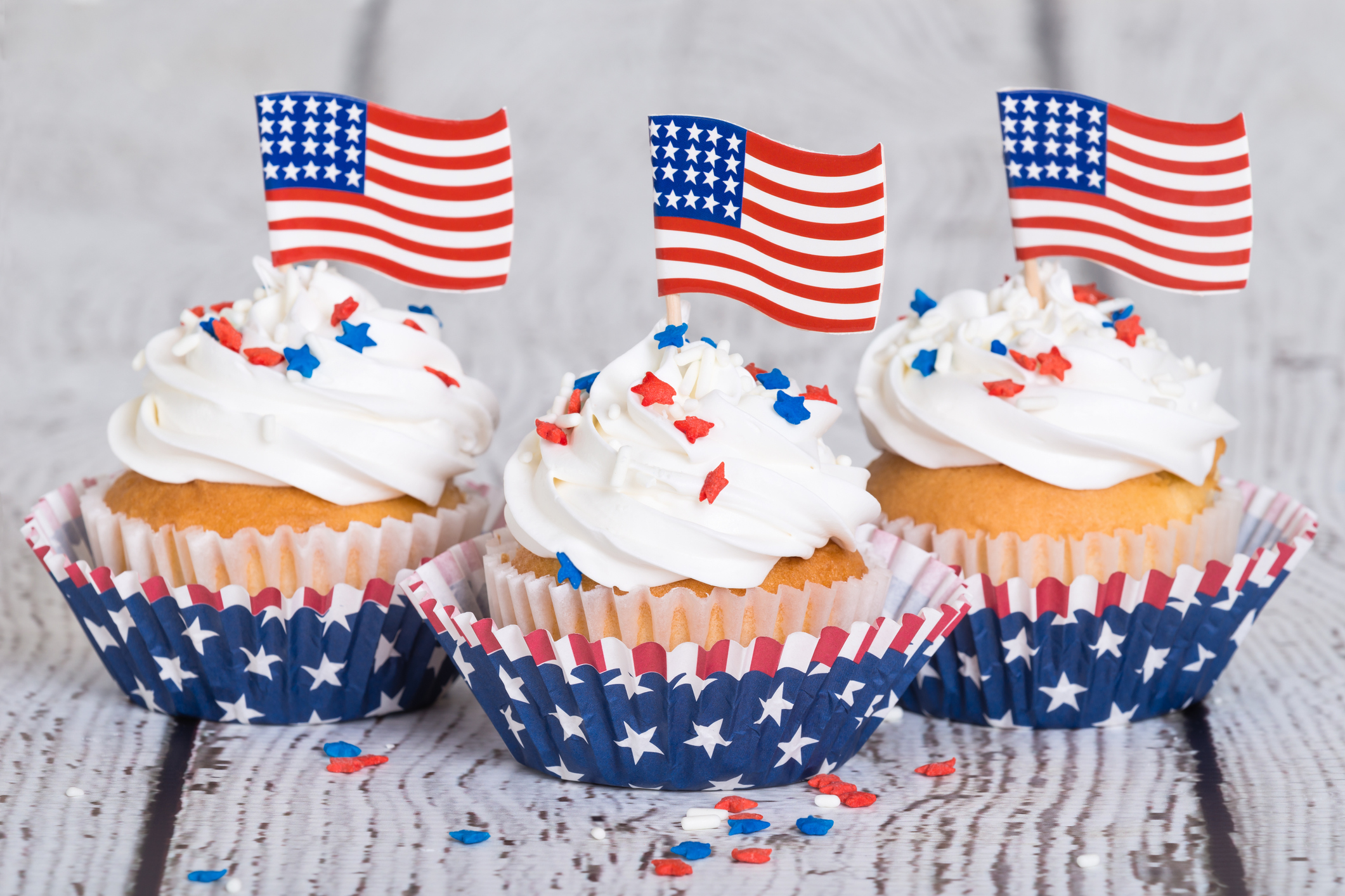 Patriotic cupcakes with sprinkles and American flags