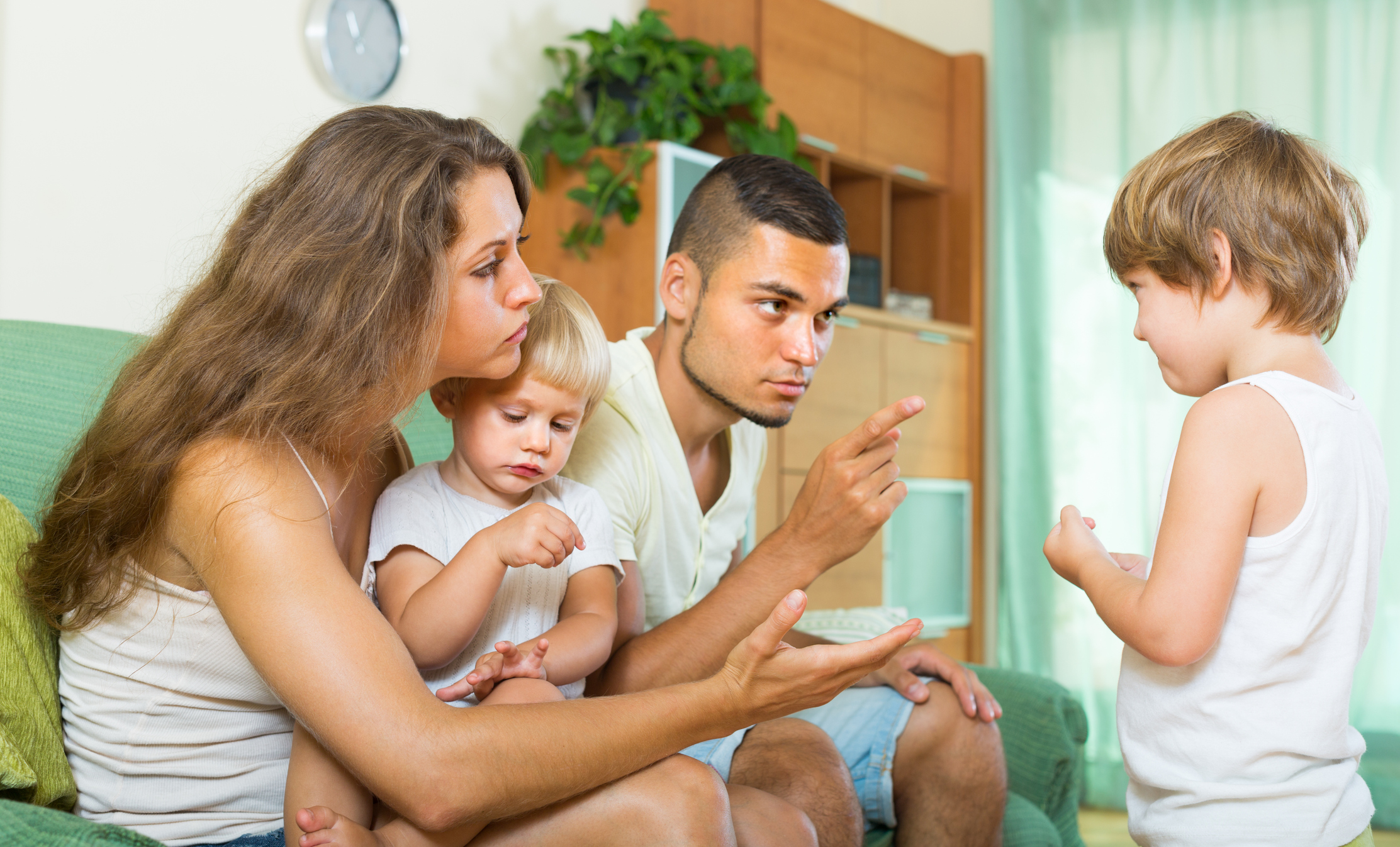 Couple scolding little daughter