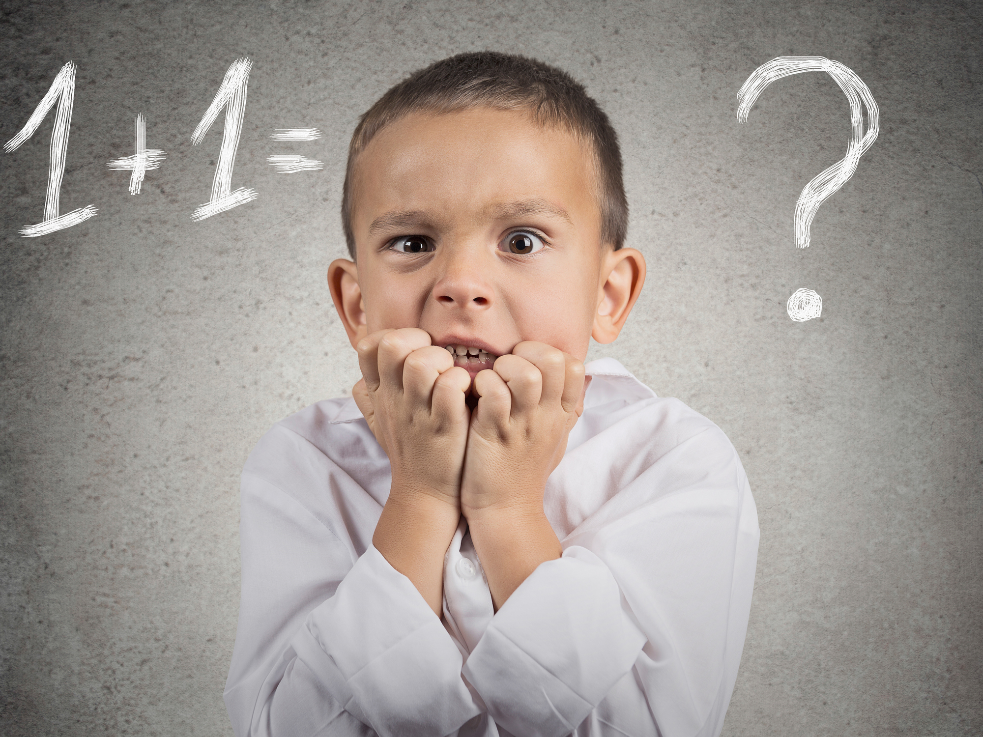 Confused, anxious boy trying to solve math problem