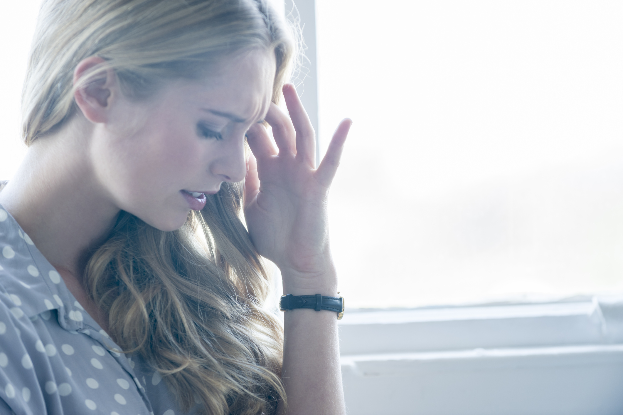 Woman looking upset or in pain.