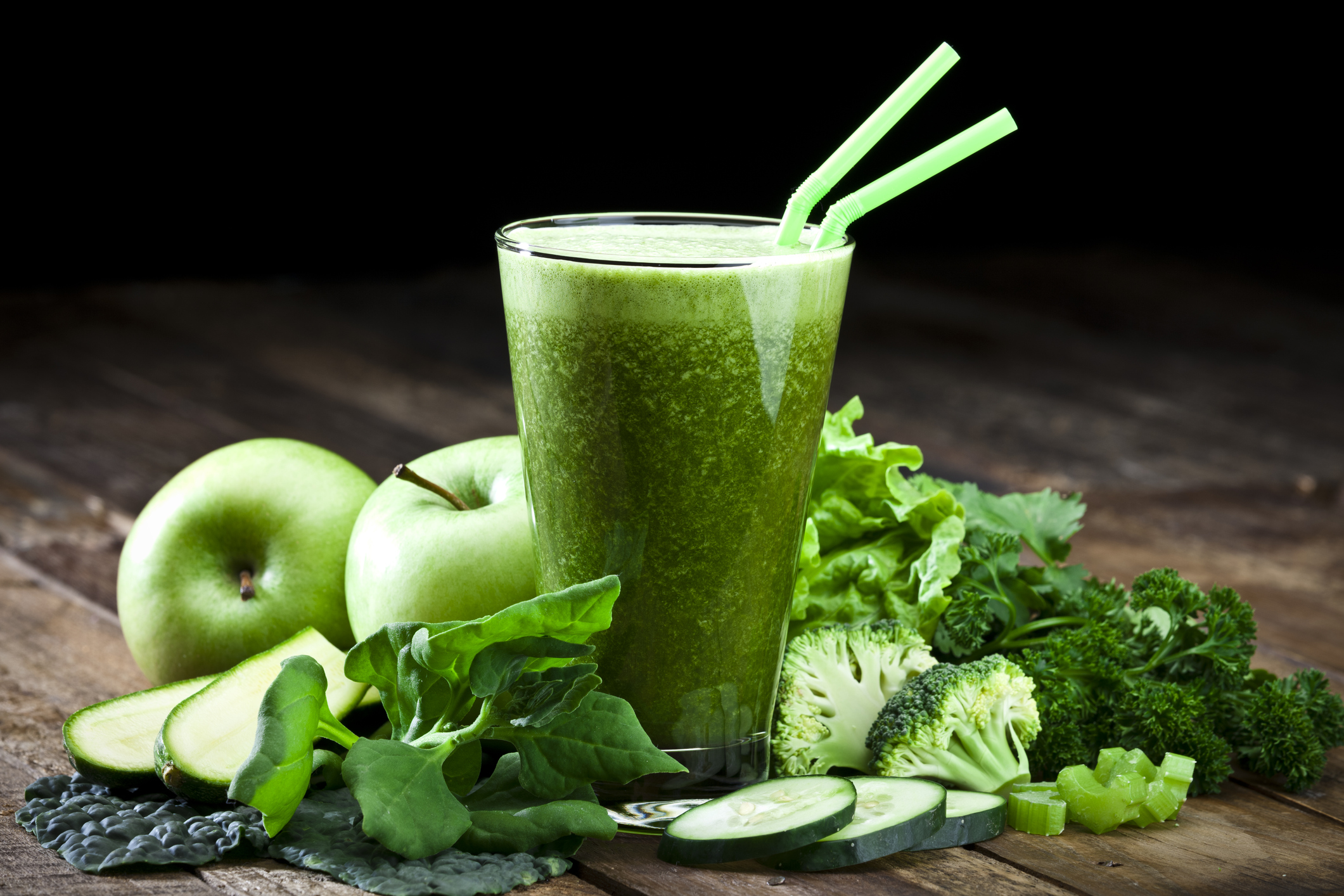 Green vegetable juice on rustic wood table