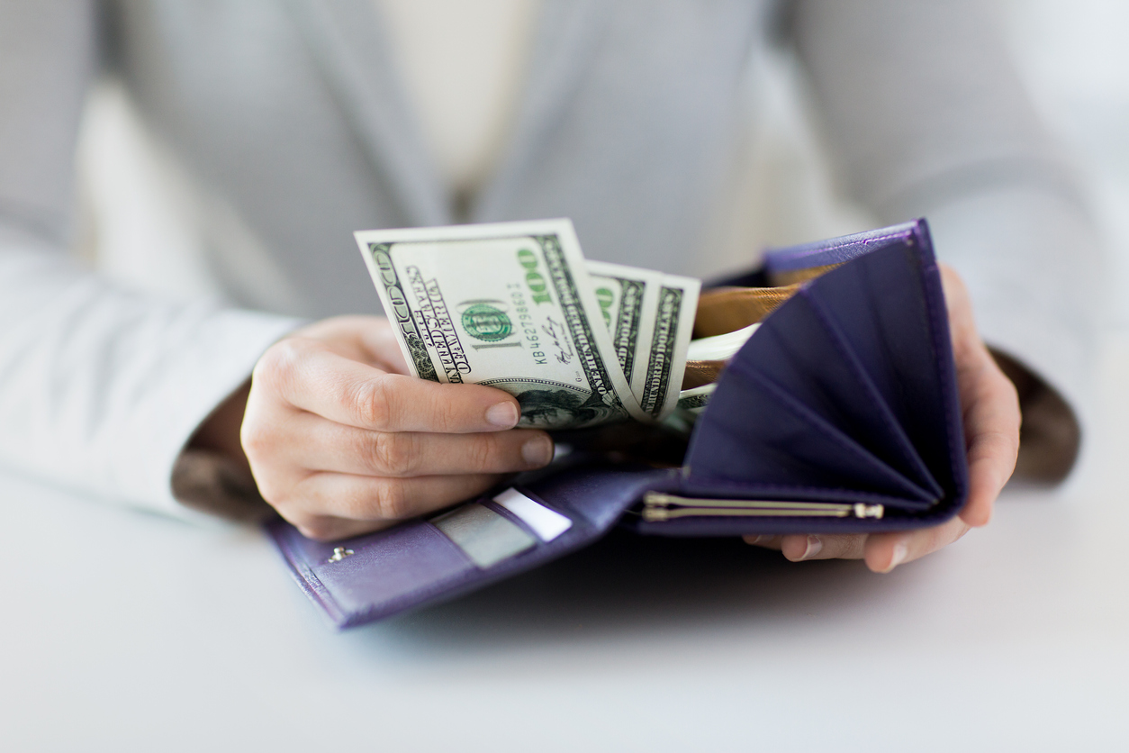 close up of woman hands with wallet and money