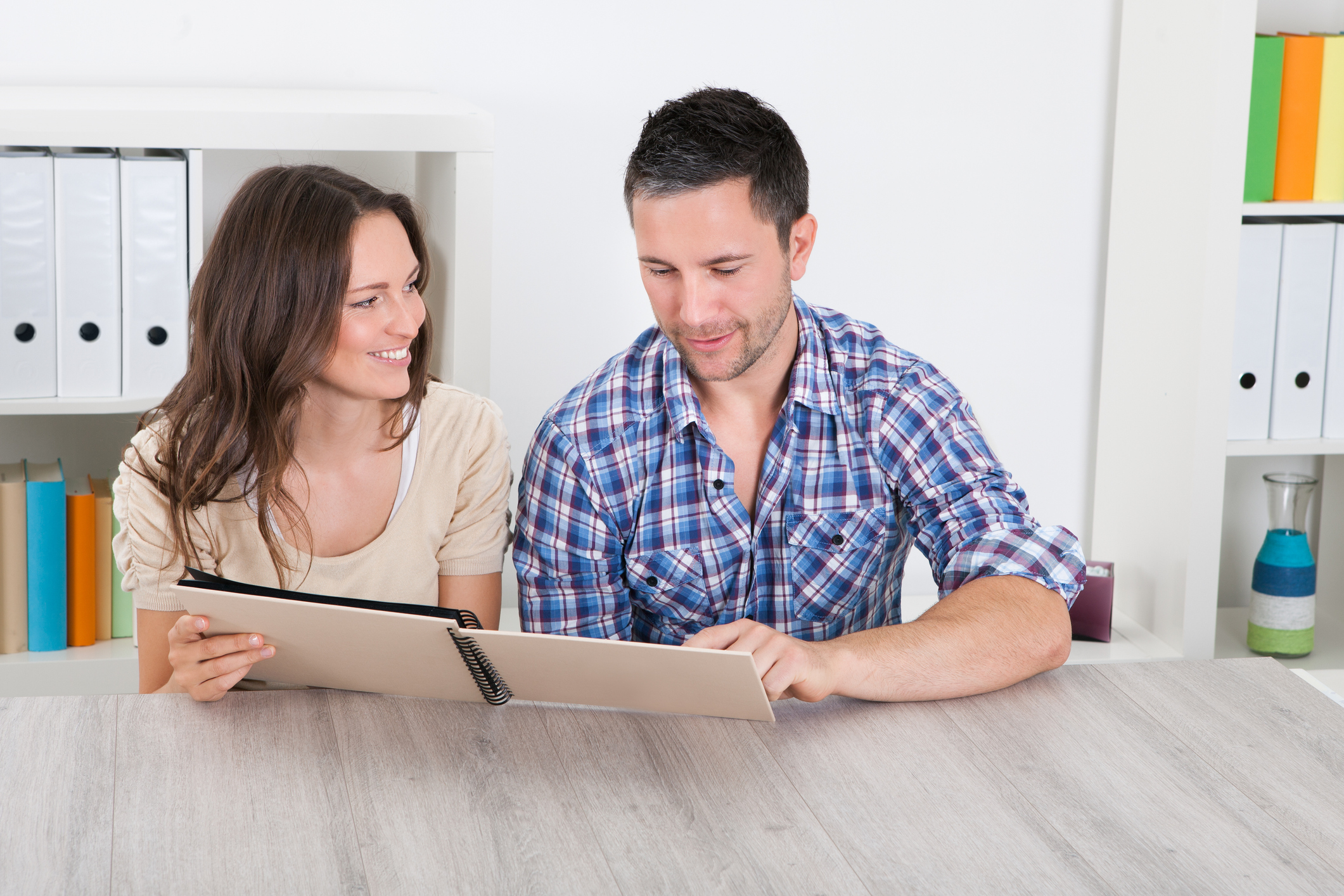 Happy Couple Looking At Photo Album