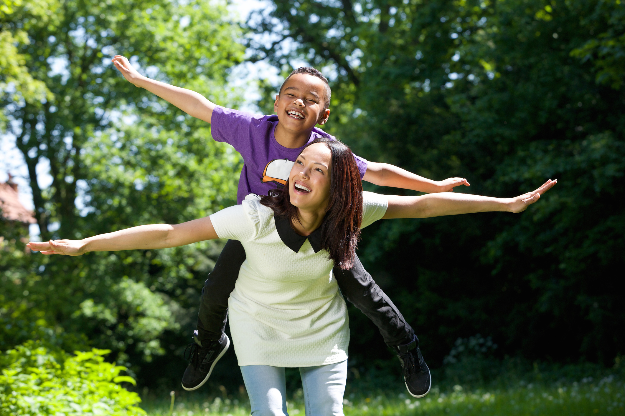 Mother and son pretending to fly