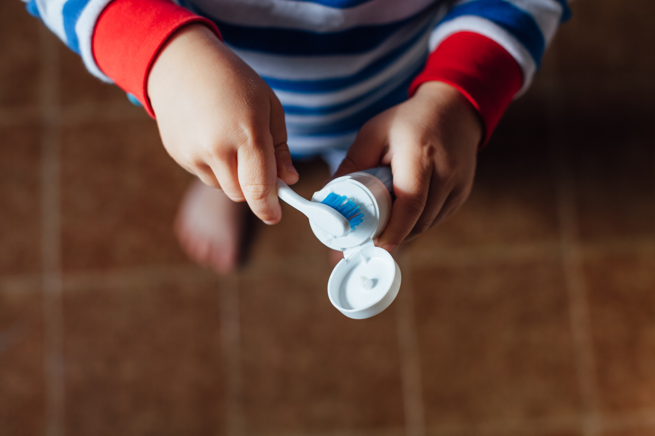 Boy taking toothpaste