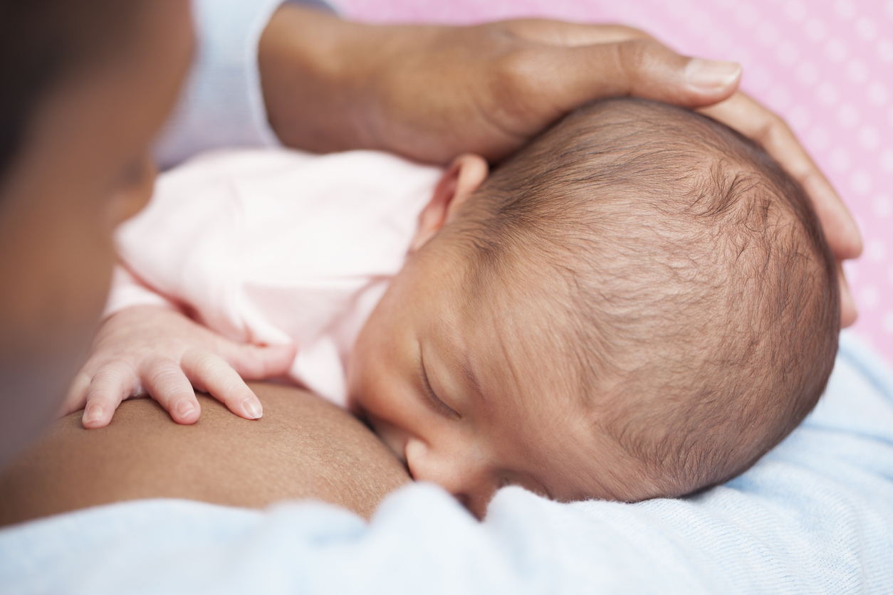 Mother breastfeeding her newborn baby.