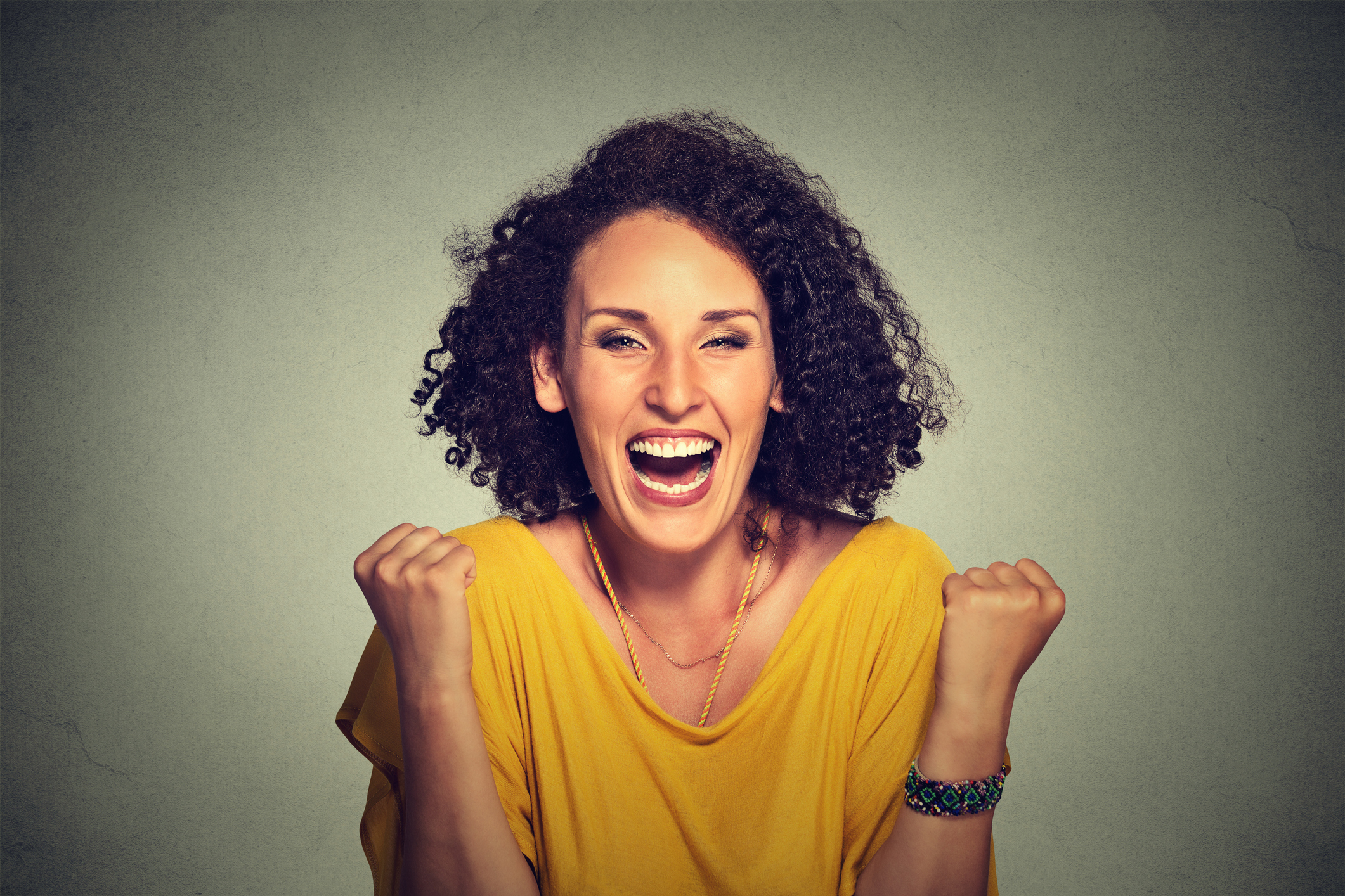 woman exults pumping fists ecstatic celebrates success