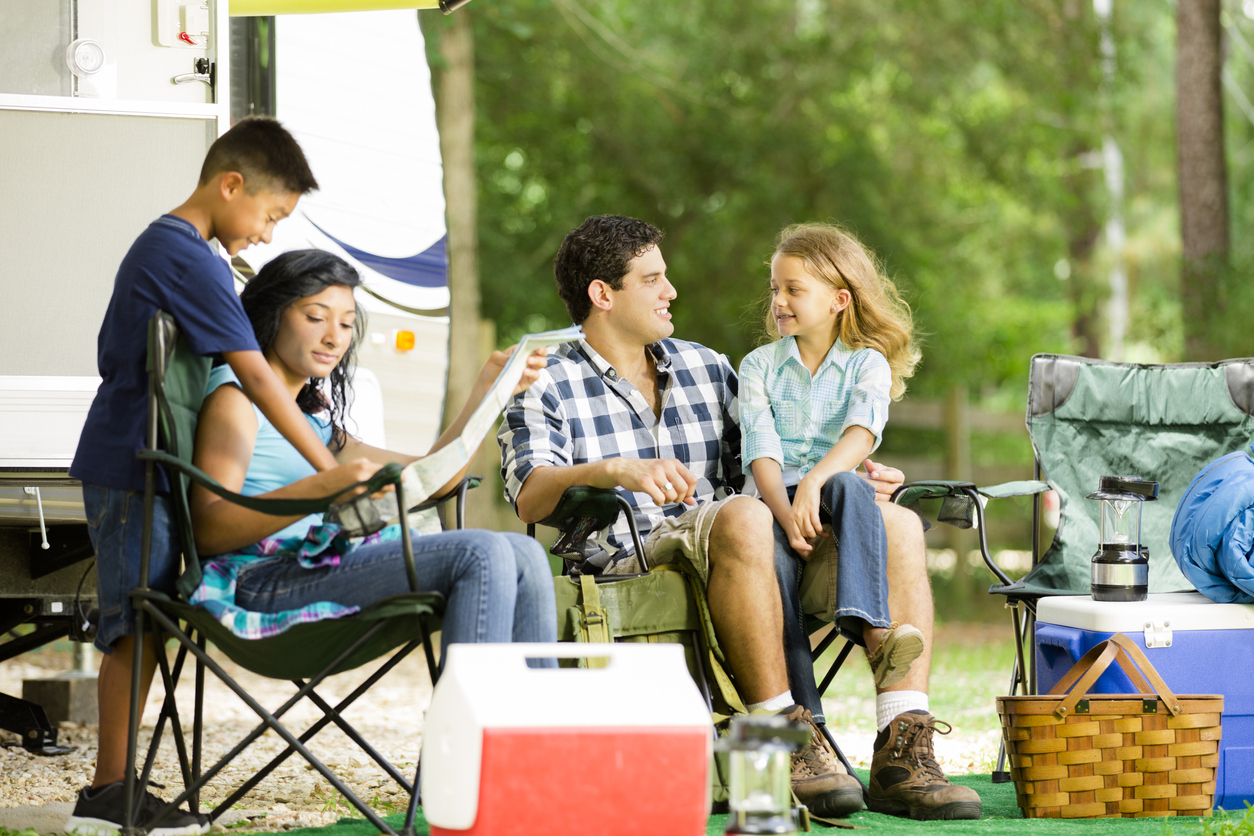 Family summer vacation. Motor home parked at national park campground.