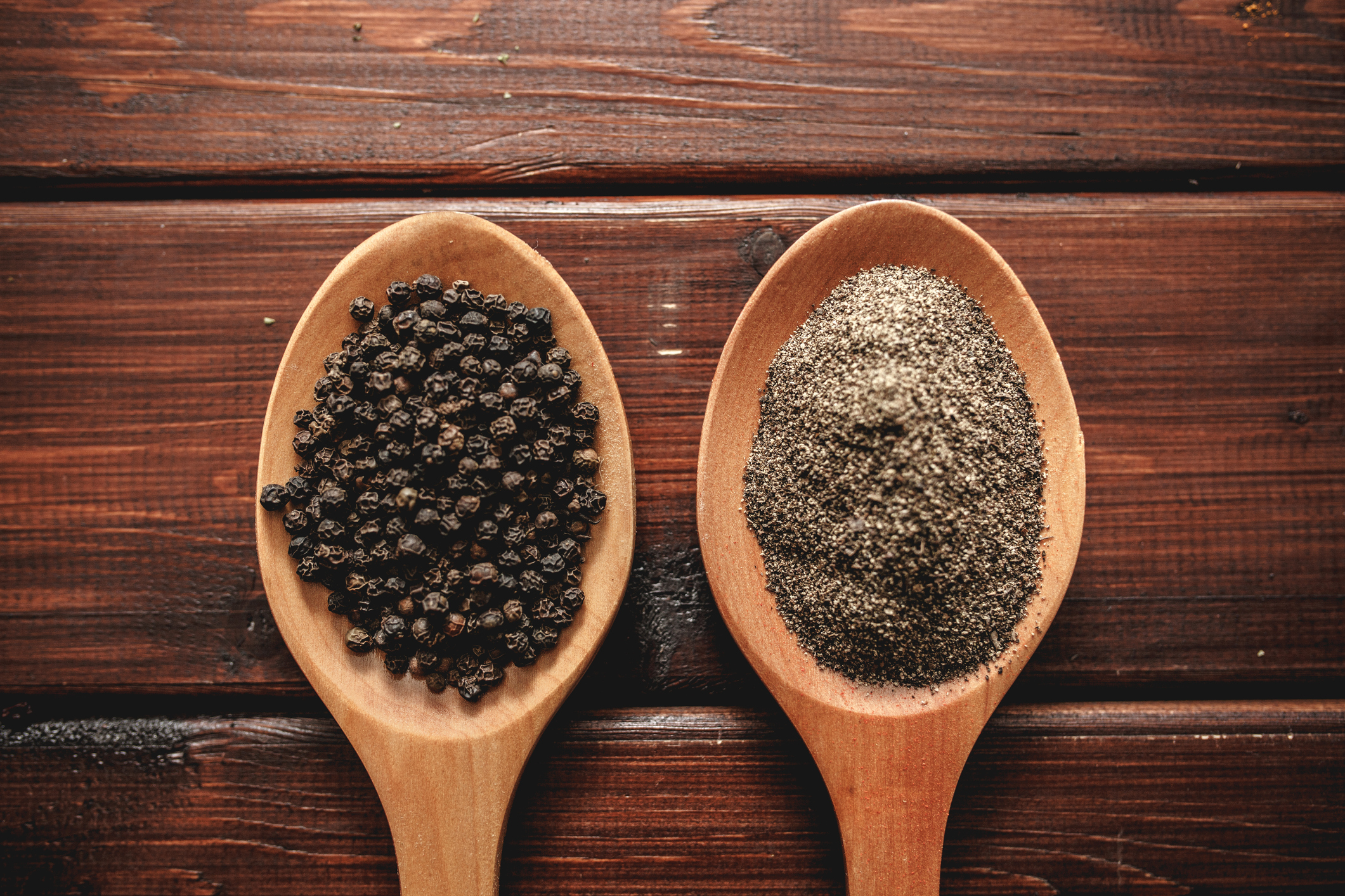 Black pepper on wooden spoon