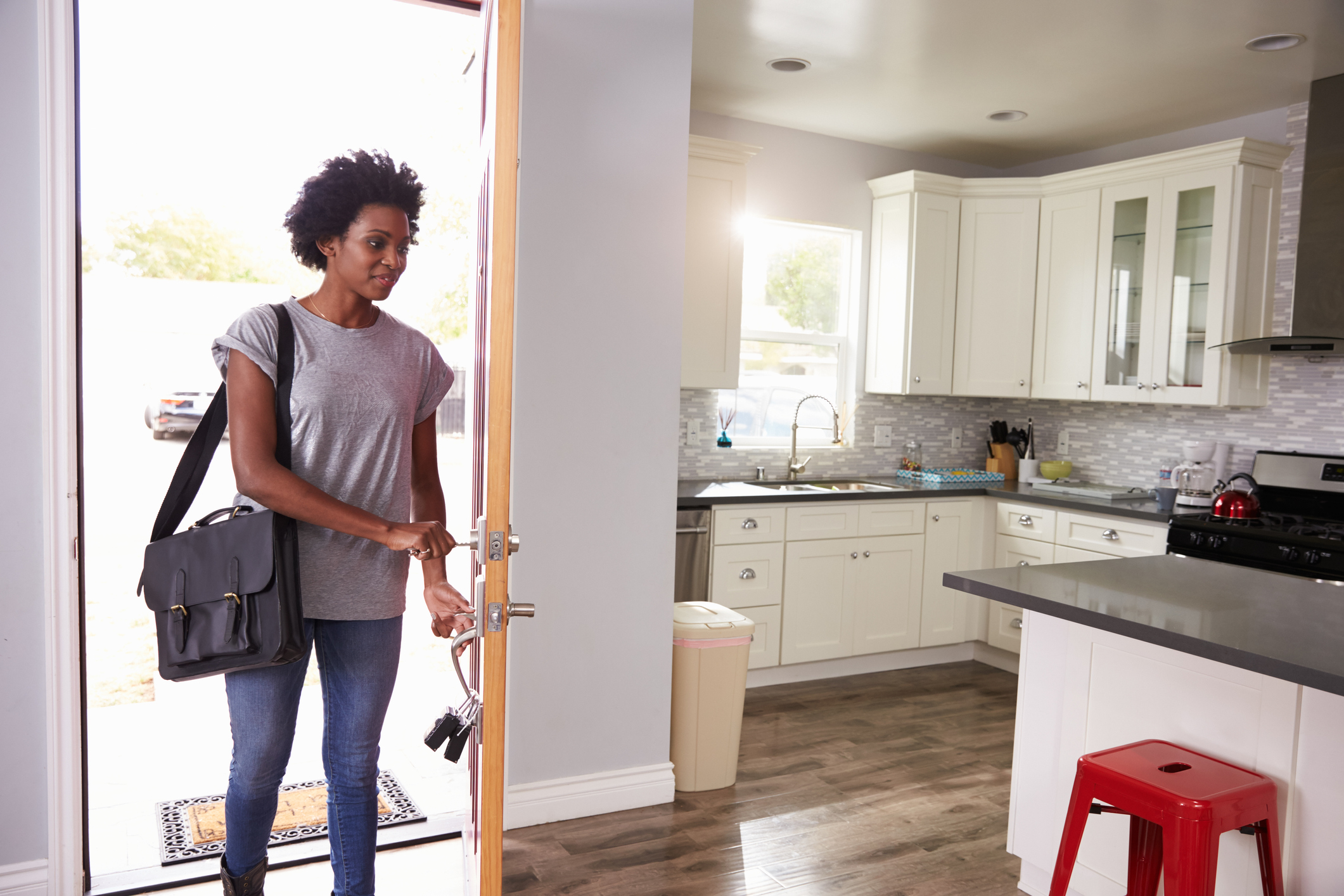 Woman Coming Home From Work And Opening Door Of Apartment