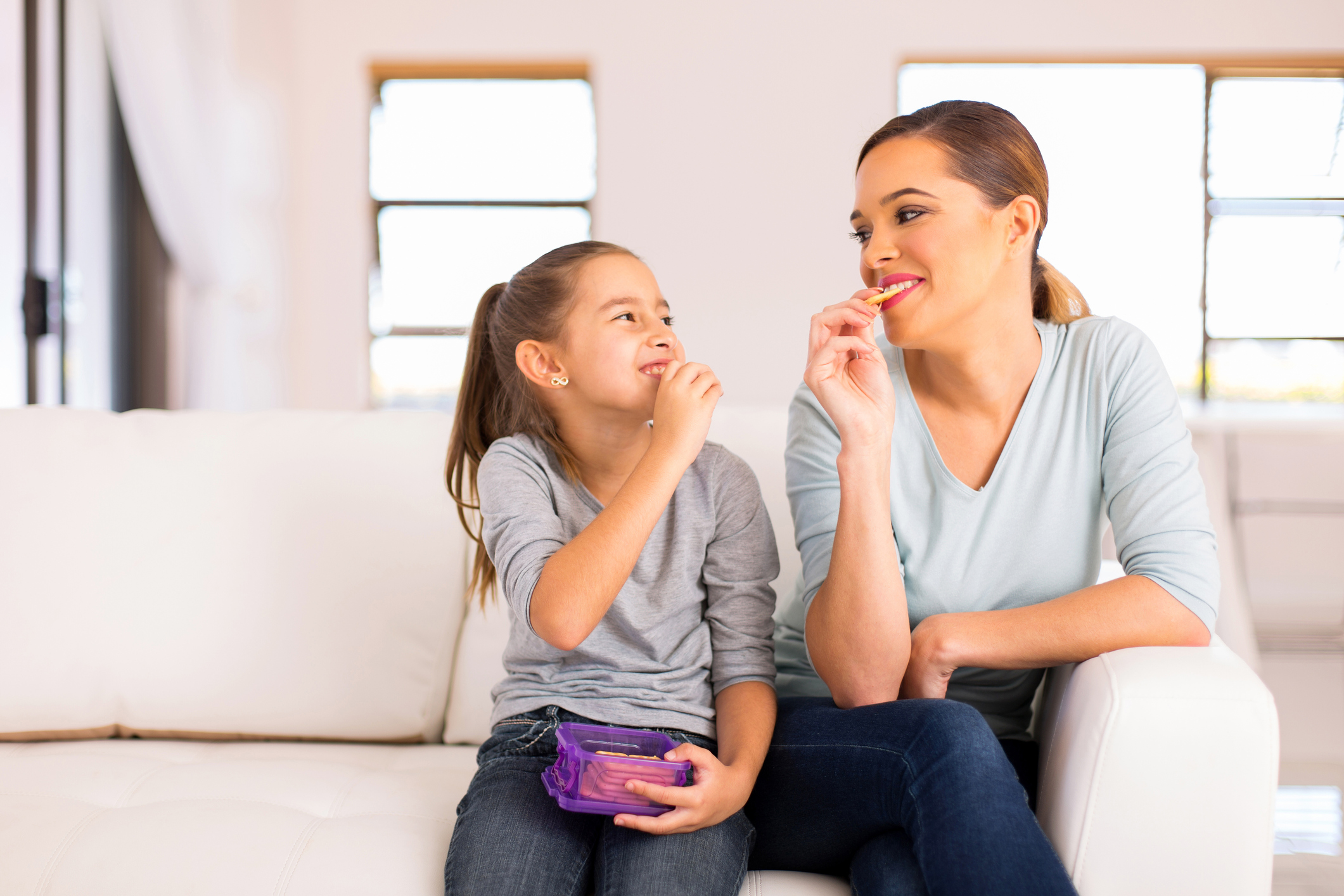 mother and daughter eating crackers