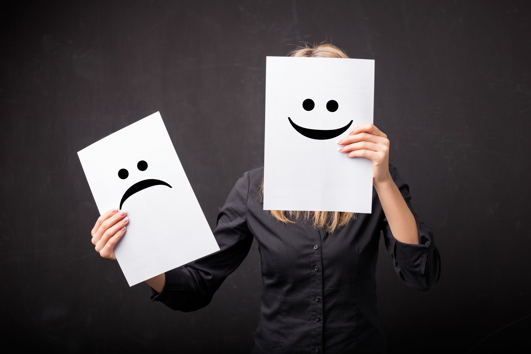 Woman changing smileys on her face