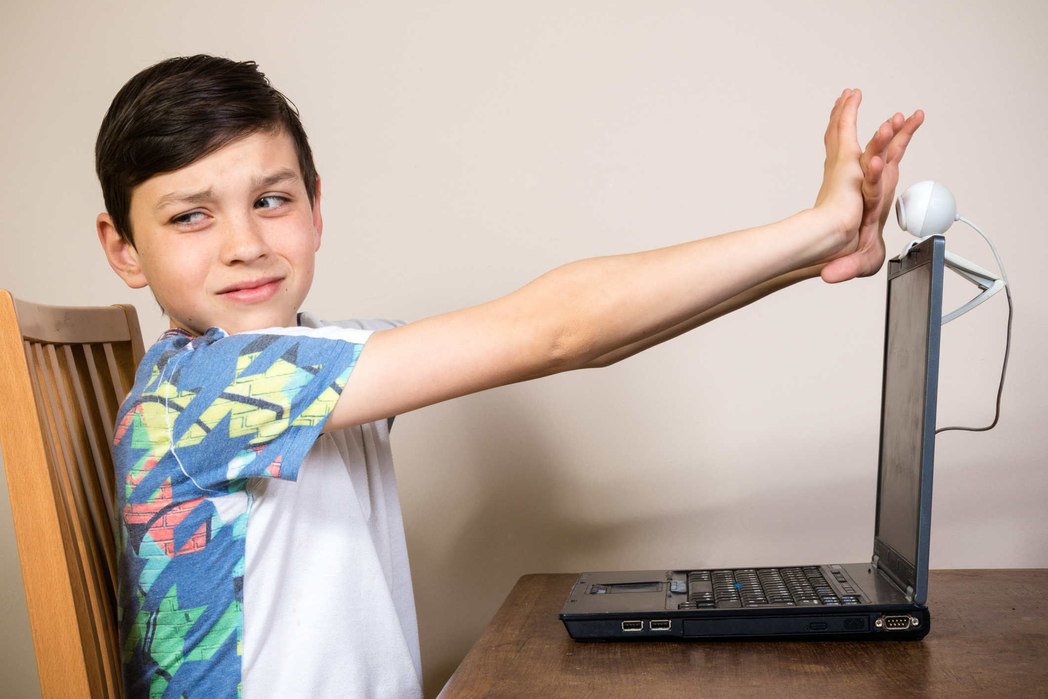 Young boy blocking a webcam