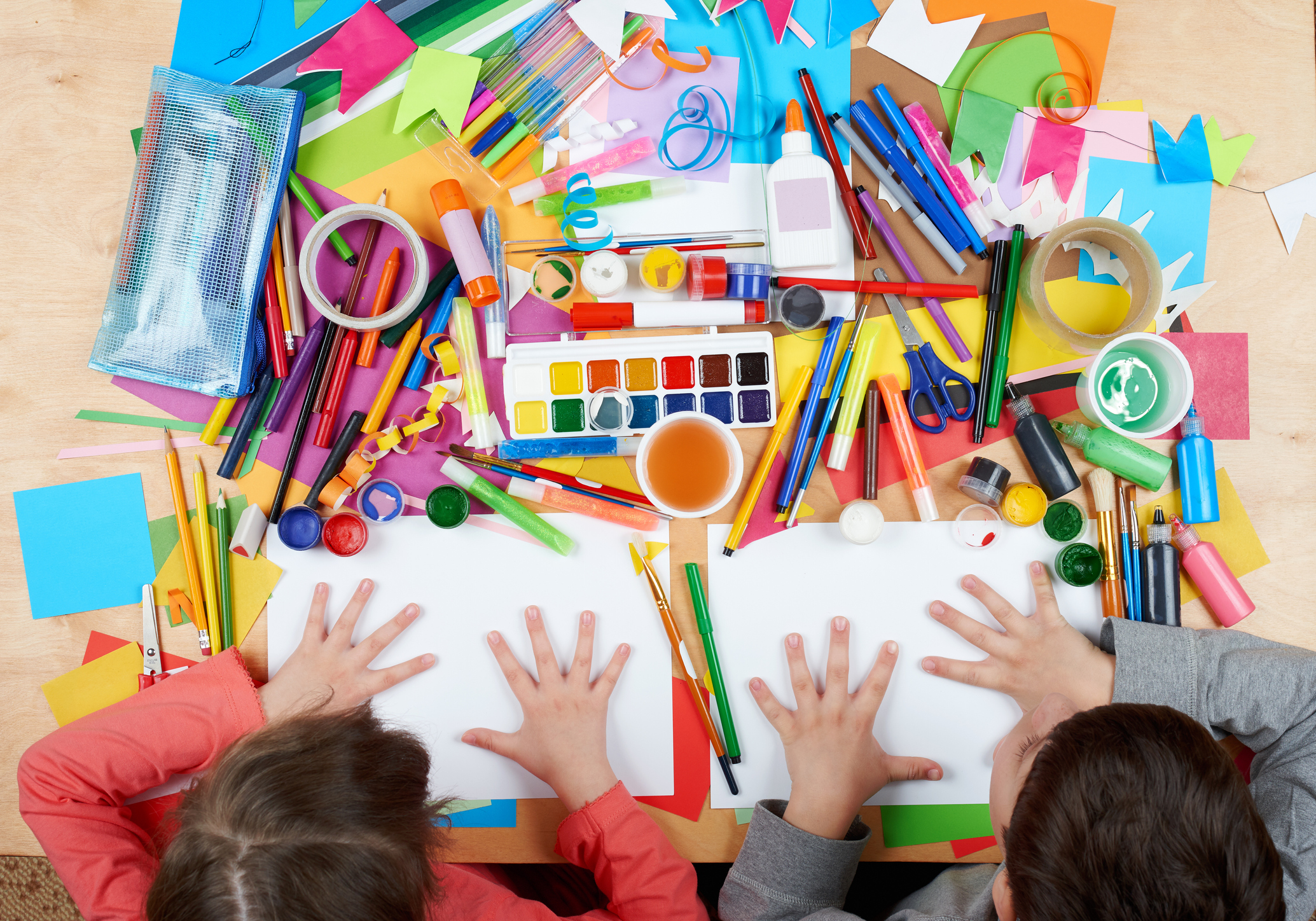 Child drawing top view. Artwork workplace with creative accessories.