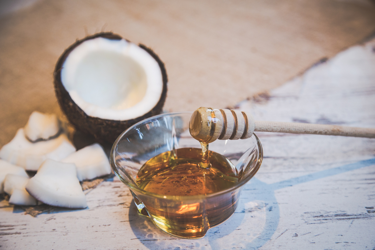 Healthy ingredients arrangement, between the bowl honey and coconut