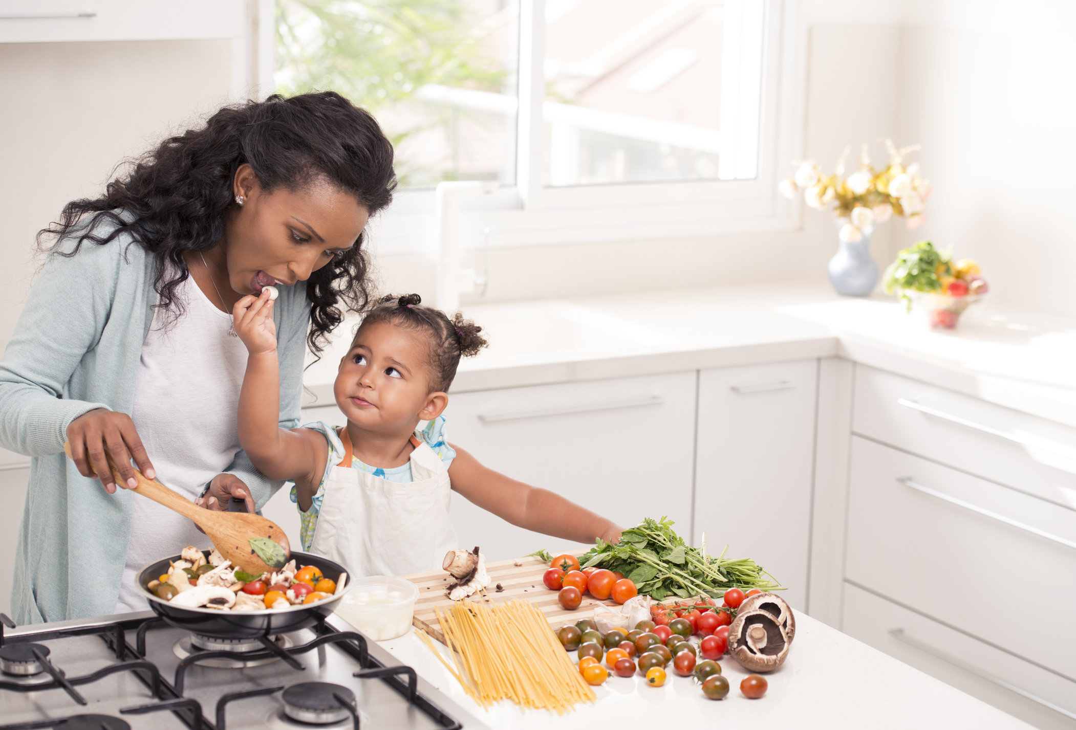 Mother and daughter cooking together.